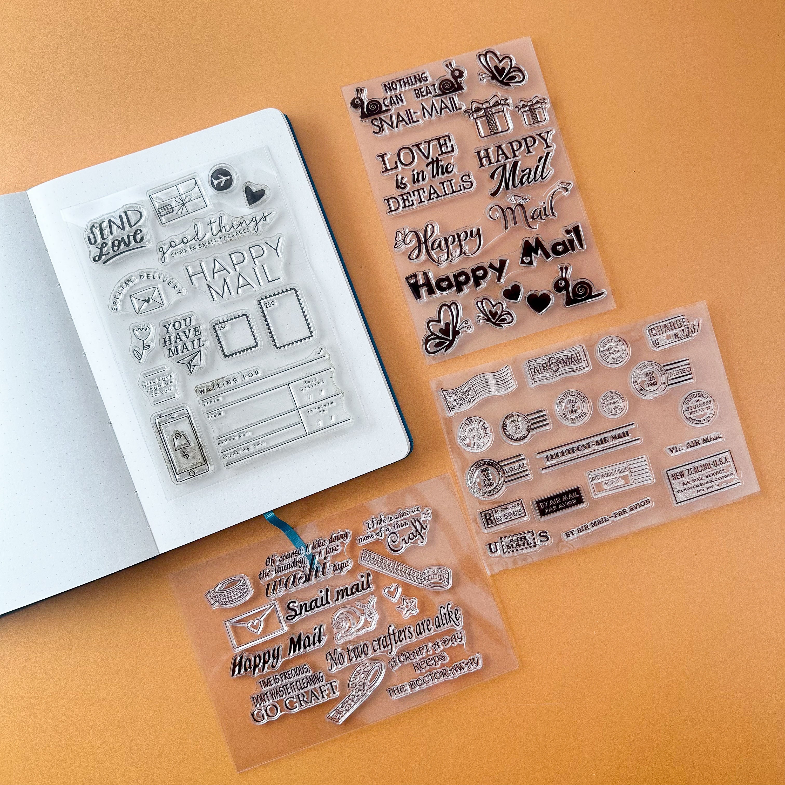 Clear stamp sets with various designs for snail mail and happy mail packages on an orange background