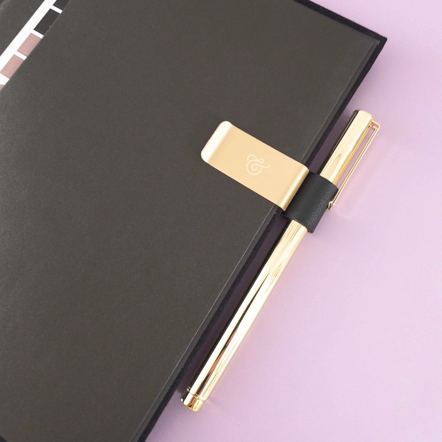Clip-On Pen Holder for journals or planners, designed for secure attachment, keeping pens or pencils easily accessible and organized.