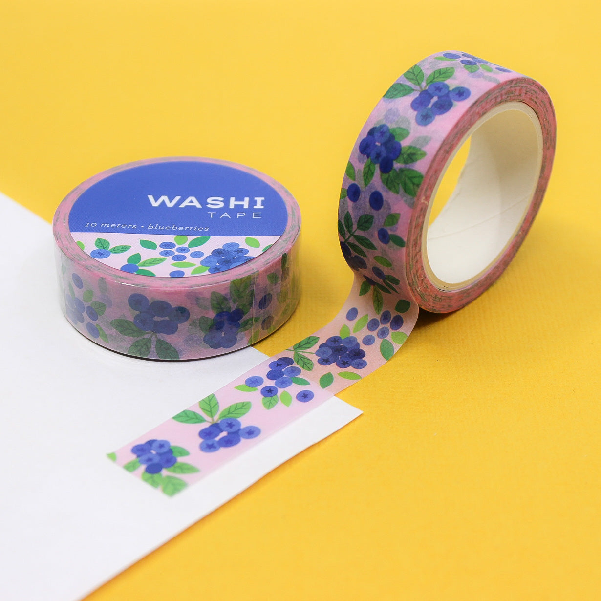 Close-up of Blueberries Washi Tape with a pink background, featuring dark blue berries on a soft pastel pink design, ideal for planners and crafts.