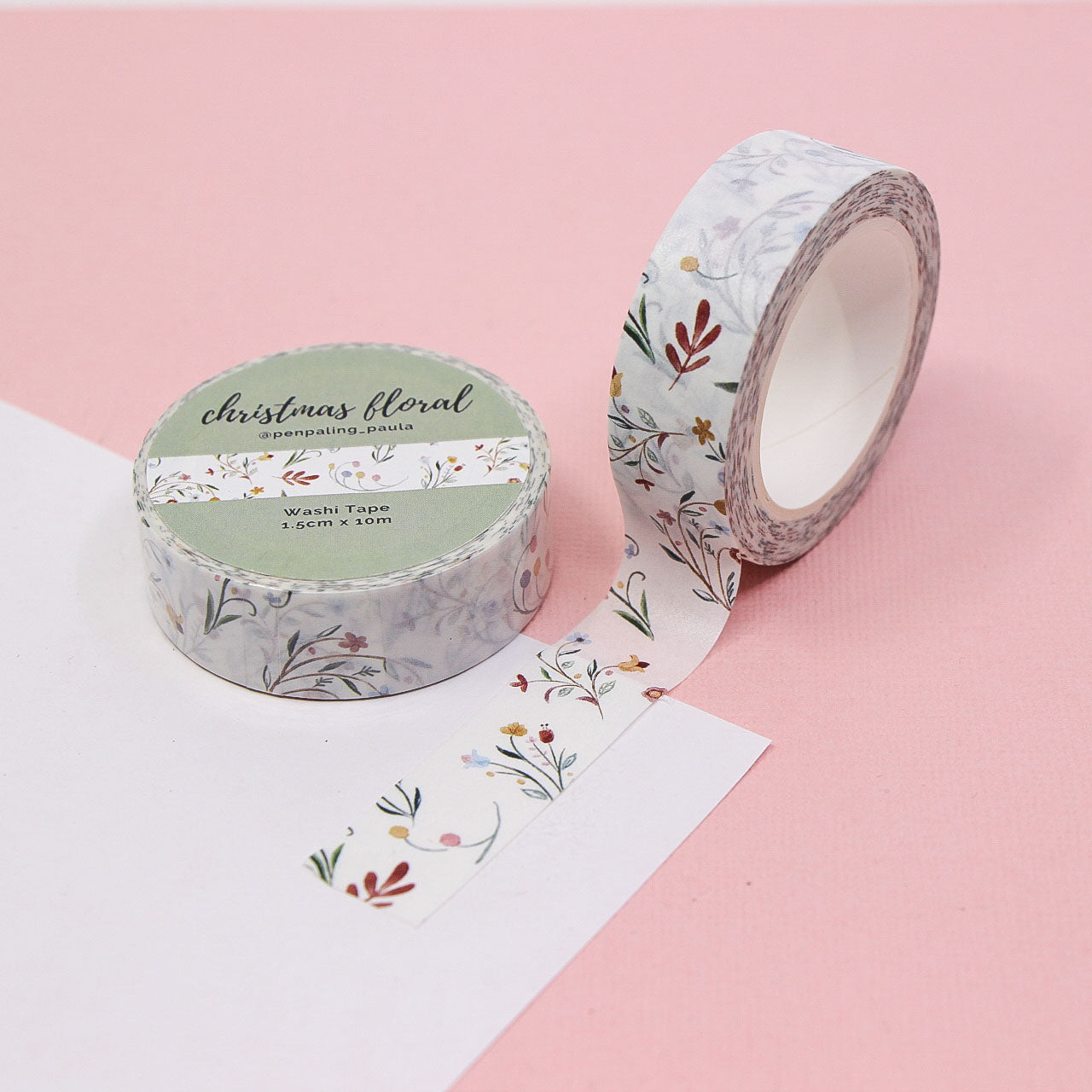Christmas washi tape roll featuring minimalist floral pattern in red, green, and gold tones for creative journaling.
