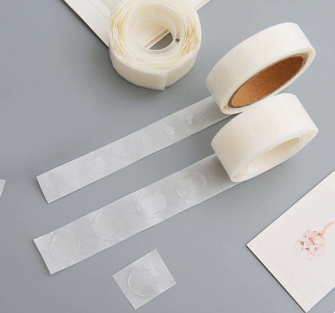 Single roll of double-sided adhesive Glue Dots for easy and mess-free crafting, ideal for scrapbooking and DIY projects.