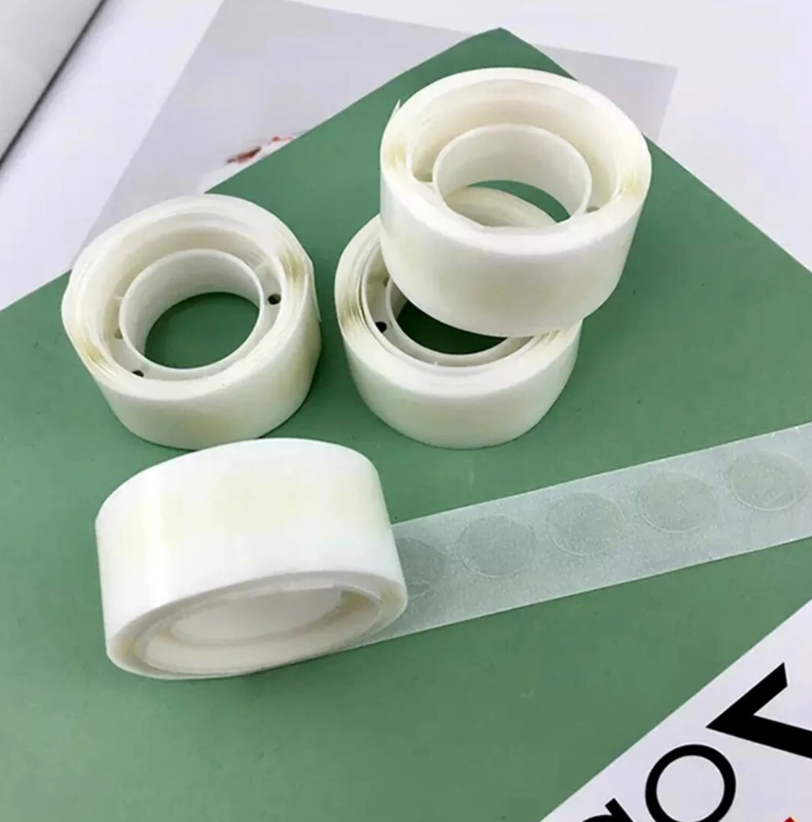 Single roll of double-sided adhesive Glue Dots for easy and mess-free crafting, ideal for scrapbooking and DIY projects.