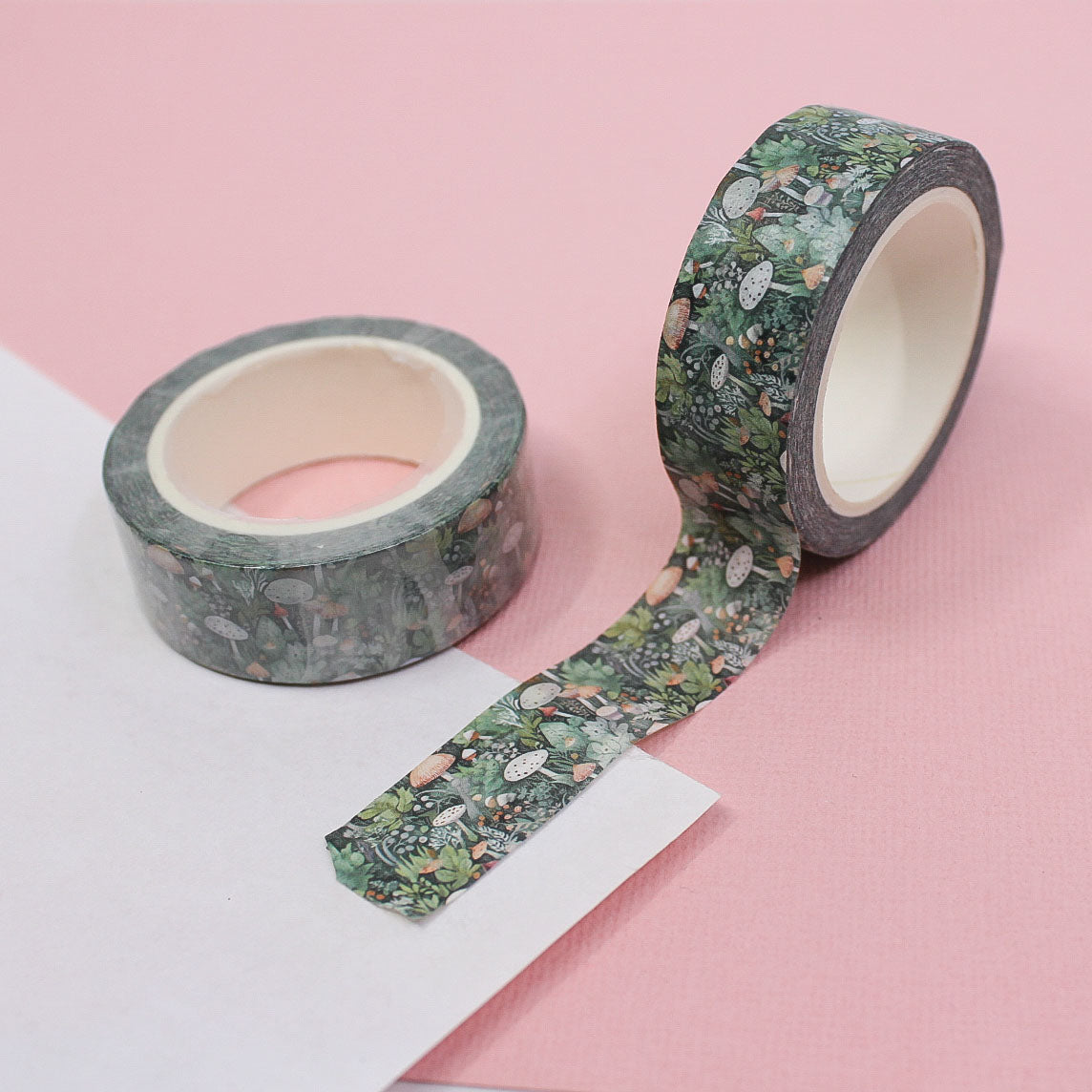 Enchant your projects with this whimsical washi tape featuring a mystical forest scene of mushrooms and foliage, ideal for nature-themed crafts and journals. This tape is sold at BBB Supplies Craft Shop.