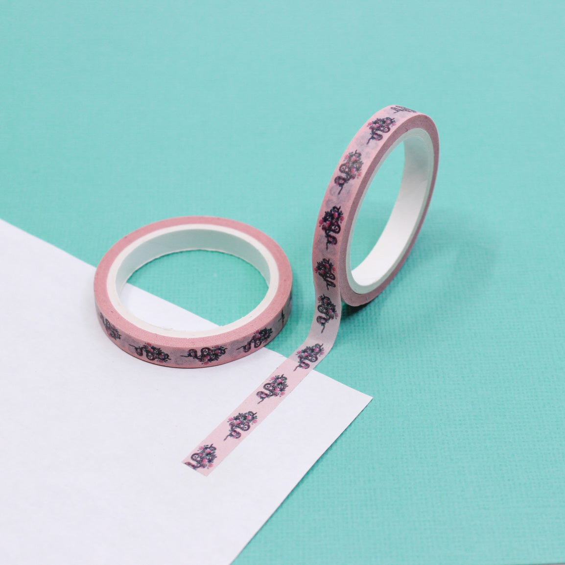Infuse your creations with a fusion of tattoo-inspired artistry using our washi tape adorned with pink snakes and intricate floral patterns, creating a unique and captivating accent for your crafts. This tape is sold at BBB Supplies Craft Shop.