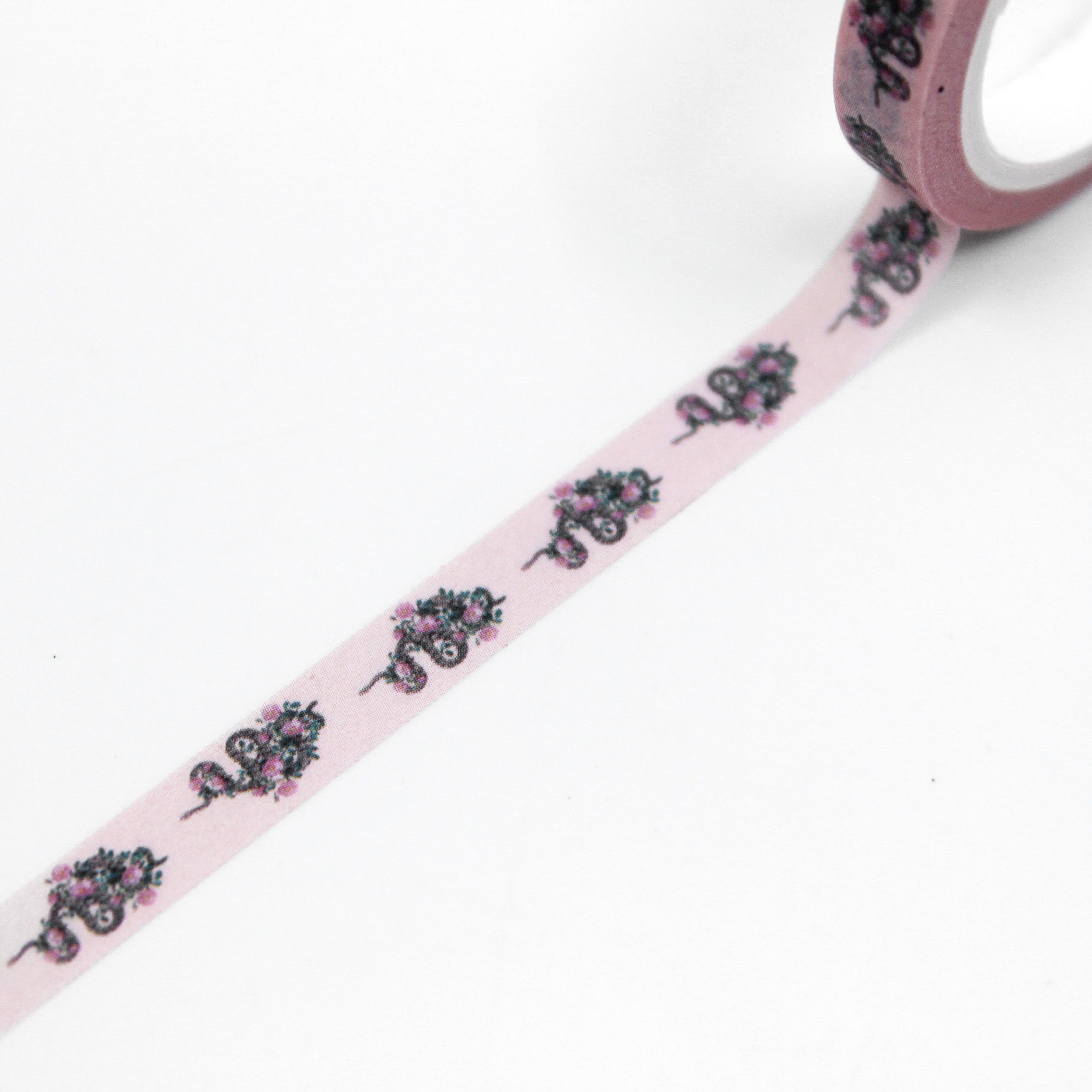 Infuse your creations with a fusion of tattoo-inspired artistry using our washi tape adorned with pink snakes and intricate floral patterns, creating a unique and captivating accent for your crafts. This tape is sold at BBB Supplies Craft Shop.