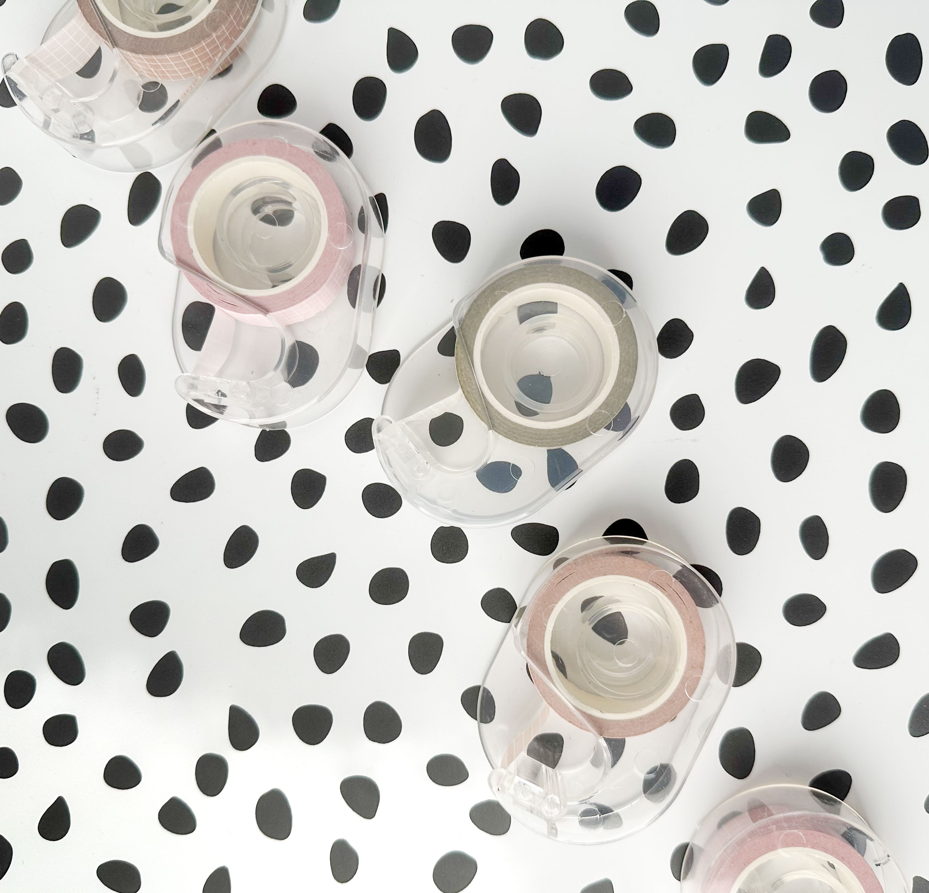 Compact plastic dispenser holding one colorful washi tape roll