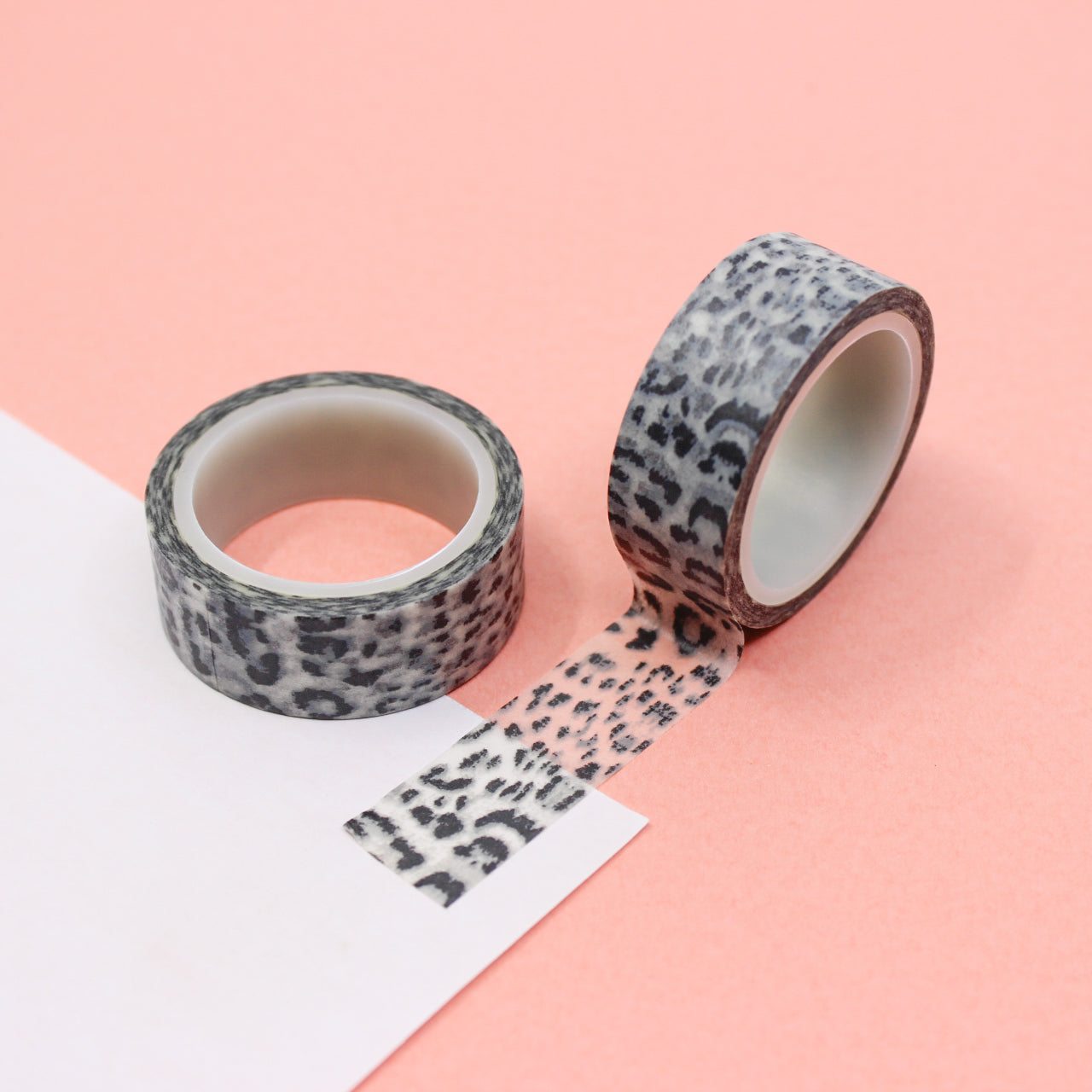 A close-up photo of snow leopard pattern washi tape. The tape features a white background with intricate black spots resembling the distinctive markings of a snow leopard. The pattern exudes elegance and captures the beauty of this majestic big cat. This tape is sold exclusively at BBB Supplies Craft Shop.