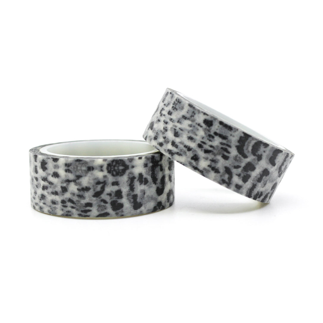 A close-up photo of snow leopard pattern washi tape. The tape features a white background with intricate black spots resembling the distinctive markings of a snow leopard. The pattern exudes elegance and captures the beauty of this majestic big cat. This tape is sold exclusively at BBB Supplies Craft Shop.