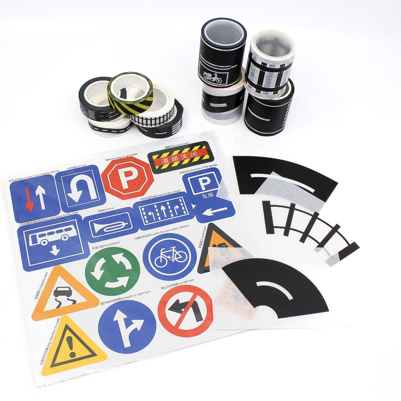 Decorative washi tape with roads, train tracks, and road signs unrolled on planner page
