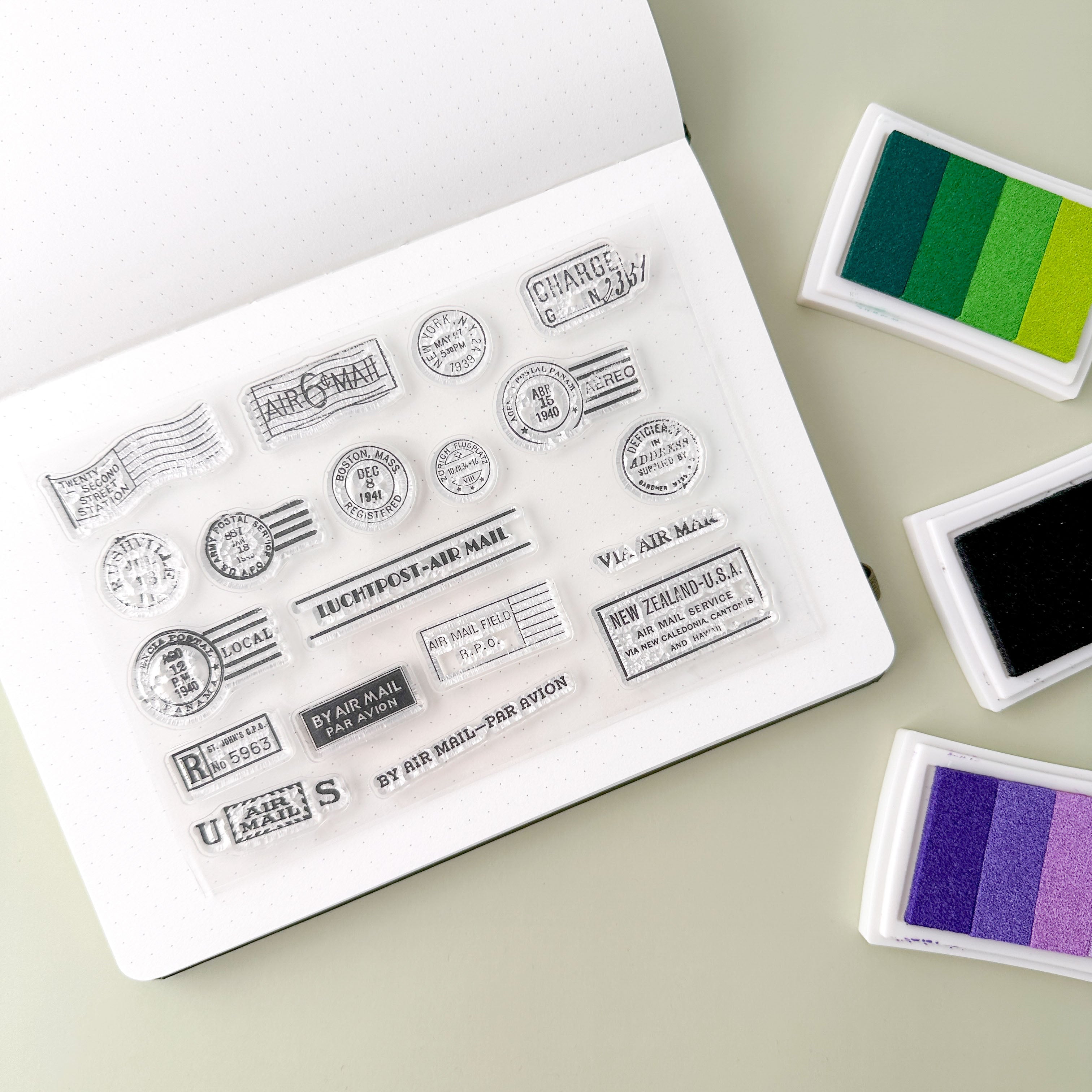 Snail Mail Acrylic stamp set featuring vintage postage, travel icons like suitcases, globes, and airplanes, perfect for travel-themed crafts.