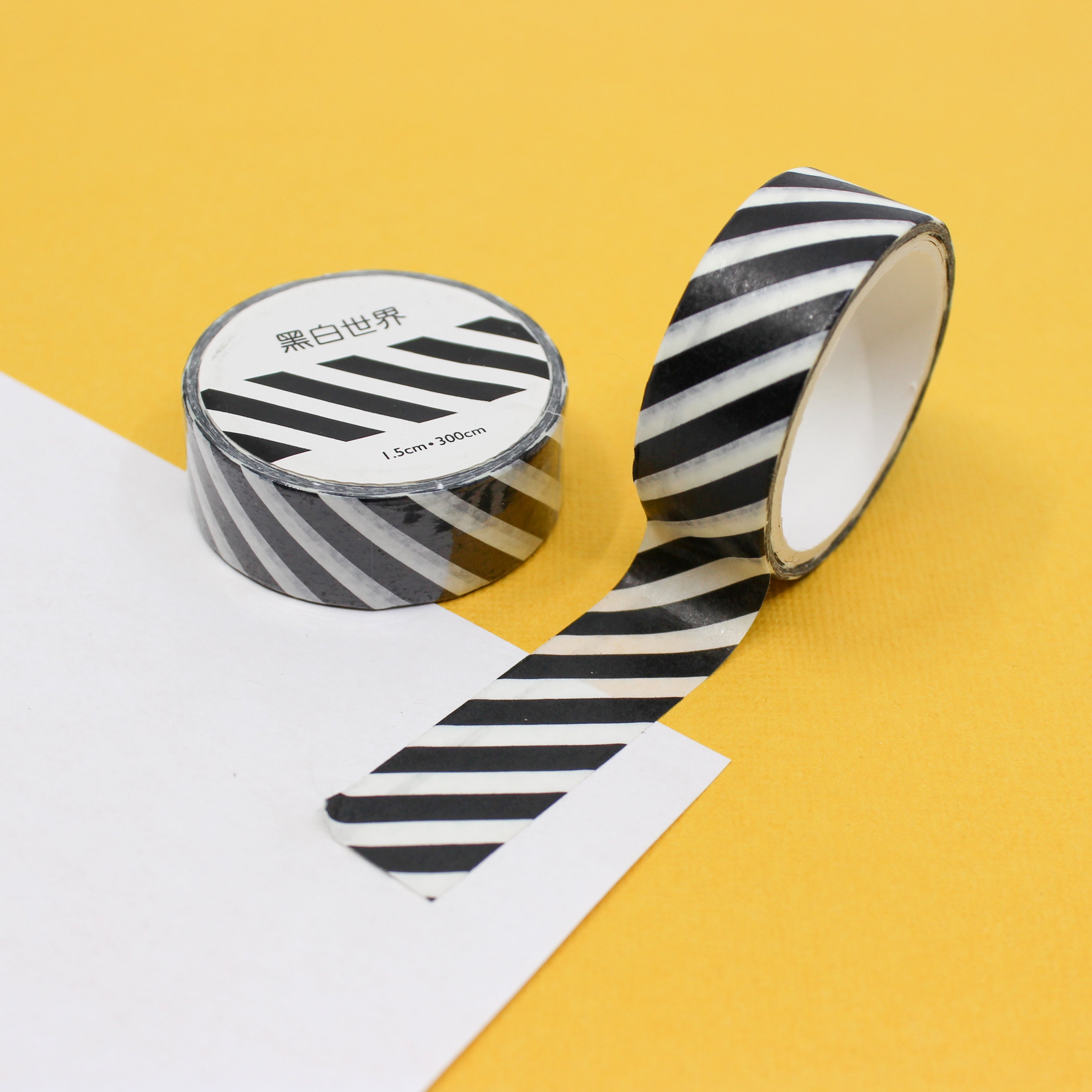 Add a touch of modern sophistication with our black and white striped washi tape, featuring a sleek and stylish pattern of diagonal stripes. This tape is sold at BBB Supplies Craft Shop.