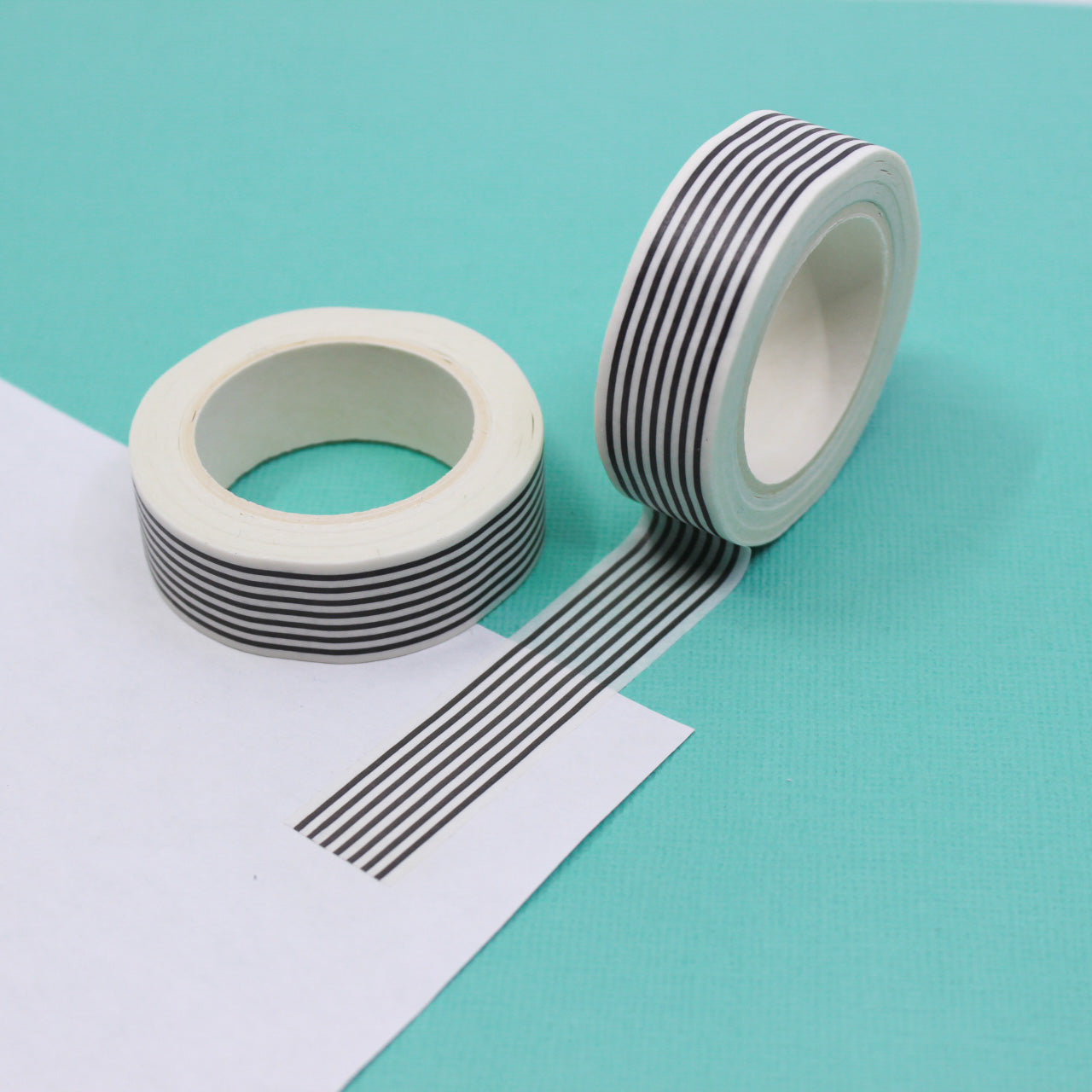 Add a timeless touch to your projects with our Classic Black & White Stripe Washi Tape, featuring a stylish and versatile stripe pattern. Ideal for creating a sleek and sophisticated look. This tape is sold at BBB Supplies Craft Shop.