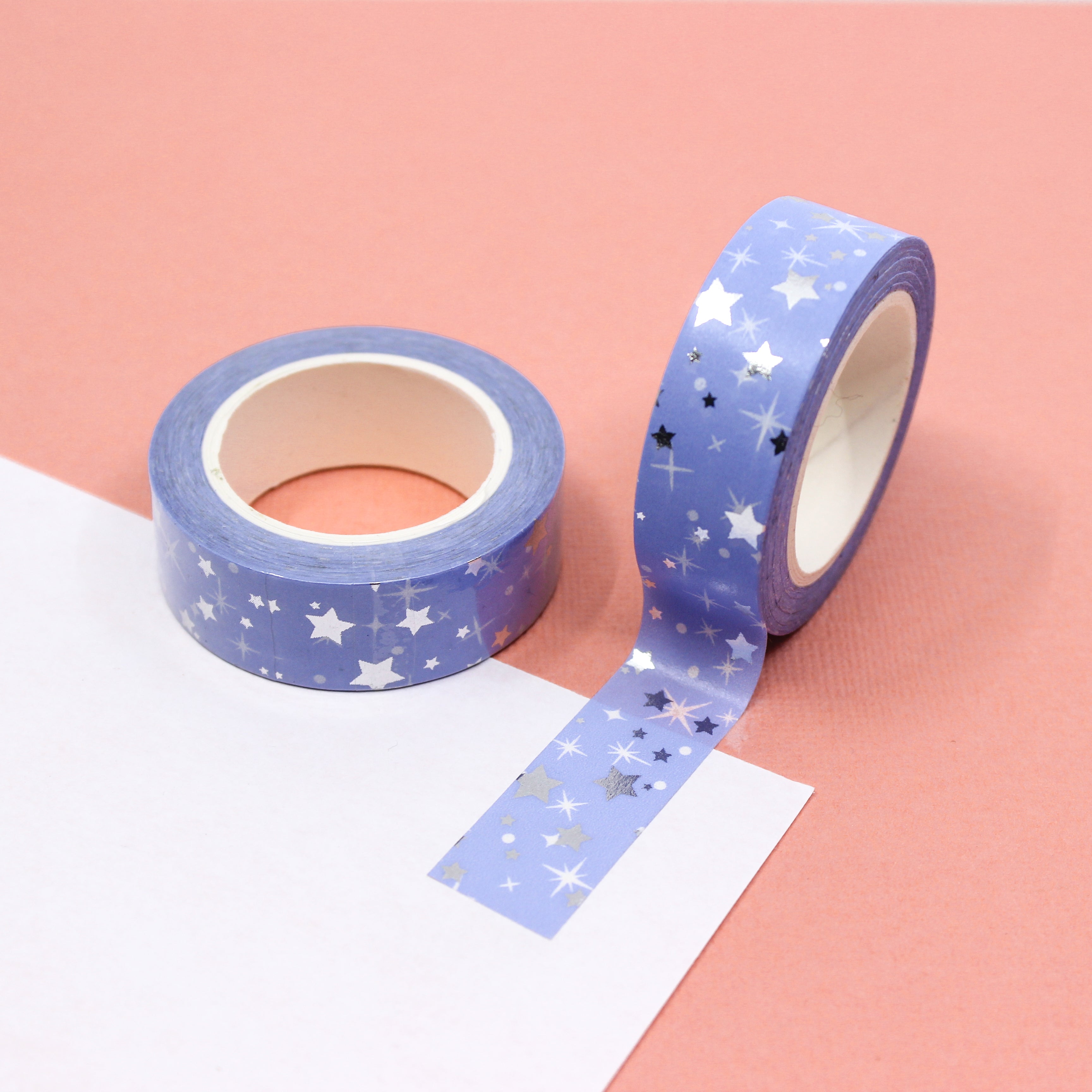 Elevate your crafts with our Blue Silver Foil Stars Washi Tape, featuring a celestial design with shimmering silver foil stars against a rich blue background. Ideal for adding a touch of cosmic elegance to your projects. This tape is sold at BBB Supplies Craft Shop.