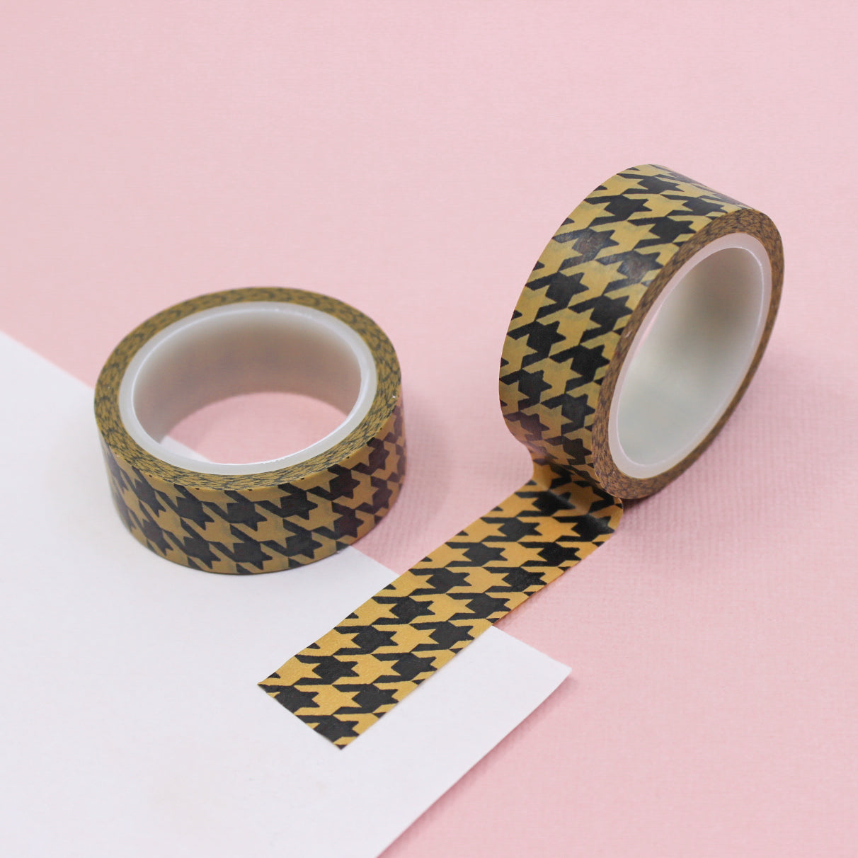 A close-up photo of Warm Brown Houndstooth Pattern Washi Tape. The tape features a classic houndstooth design in warm brown tones. The intricate pattern creates a sense of refined elegance, making it a versatile choice for various creative projects. This tape is sold exclusively at BBB Supplies Craft Shop.