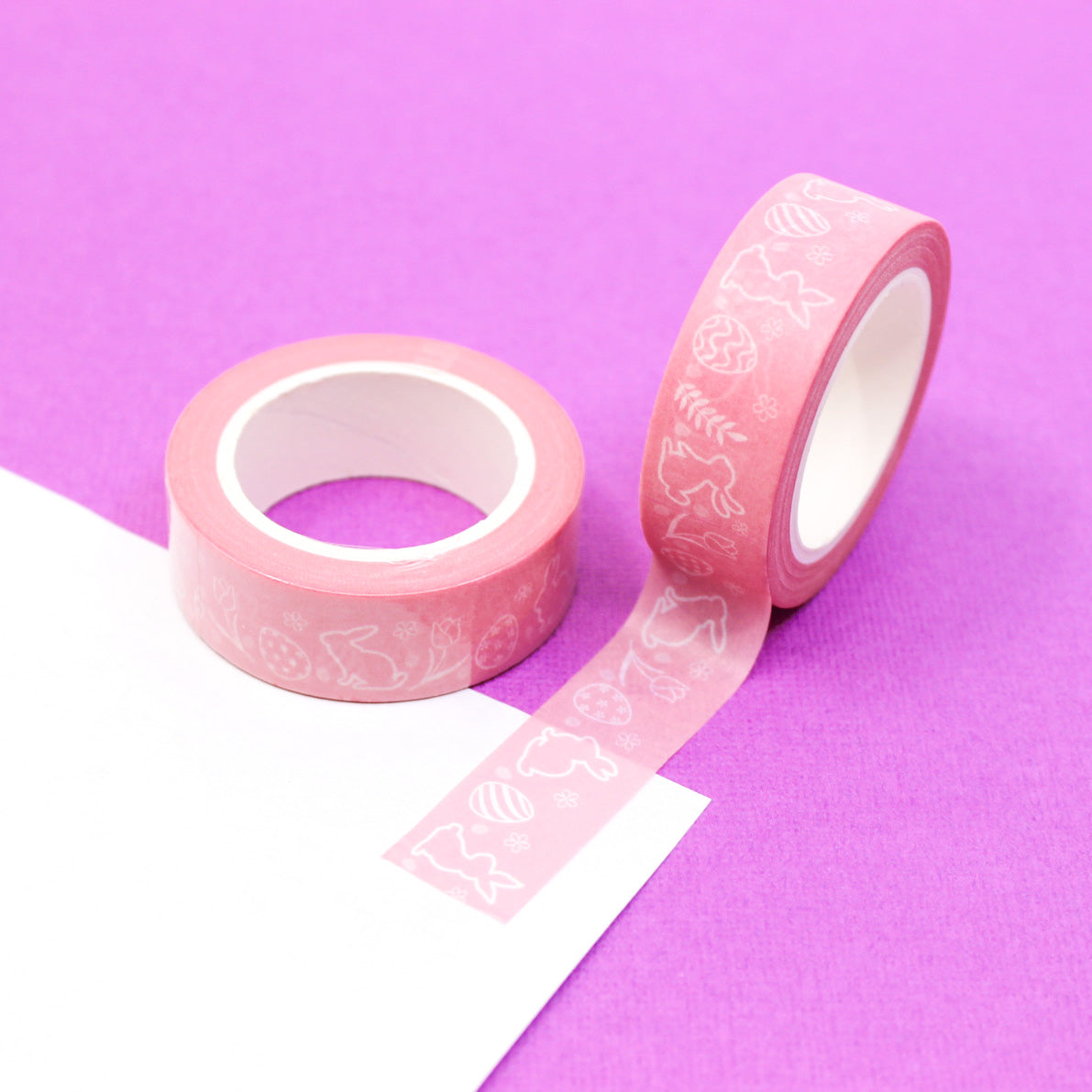 This charming tape features playful bunnies and colorful Easter eggs on a pink background, adding a delightful touch to your Easter crafts and decorations. Perfect for scrapbooking, card-making, and other creative projects. This tape is sold at BBB Supplies Craft Shop.