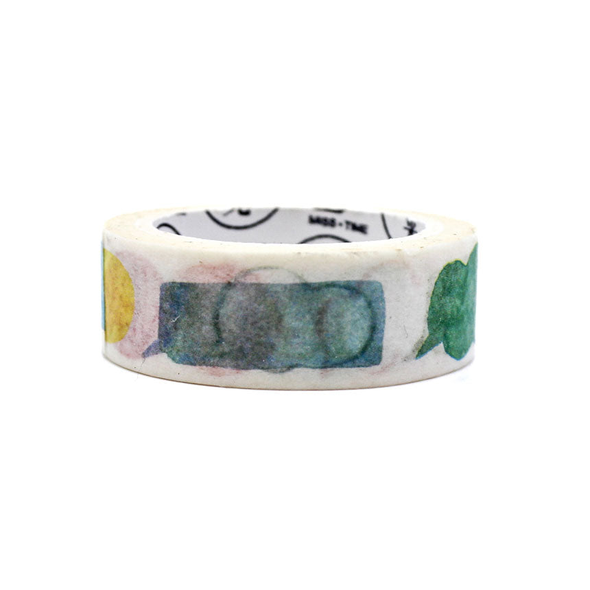 Decorative washi tape unrolled to show colorful speech-bubble-like shapes on white paper.