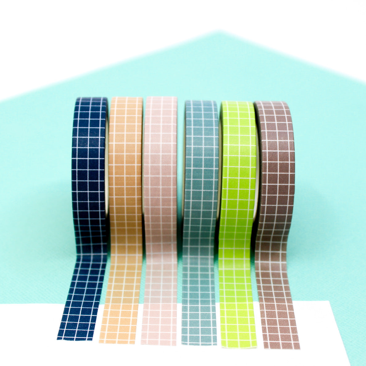These colorful narrow grid tapes are functional and decorative, making them a must have for any planner, journal or calendar. These tapes come in Navy Blue, Blue, Pink, Green, Brown, and peachy Tan and are sold at BBB Supplies Craft Shop.