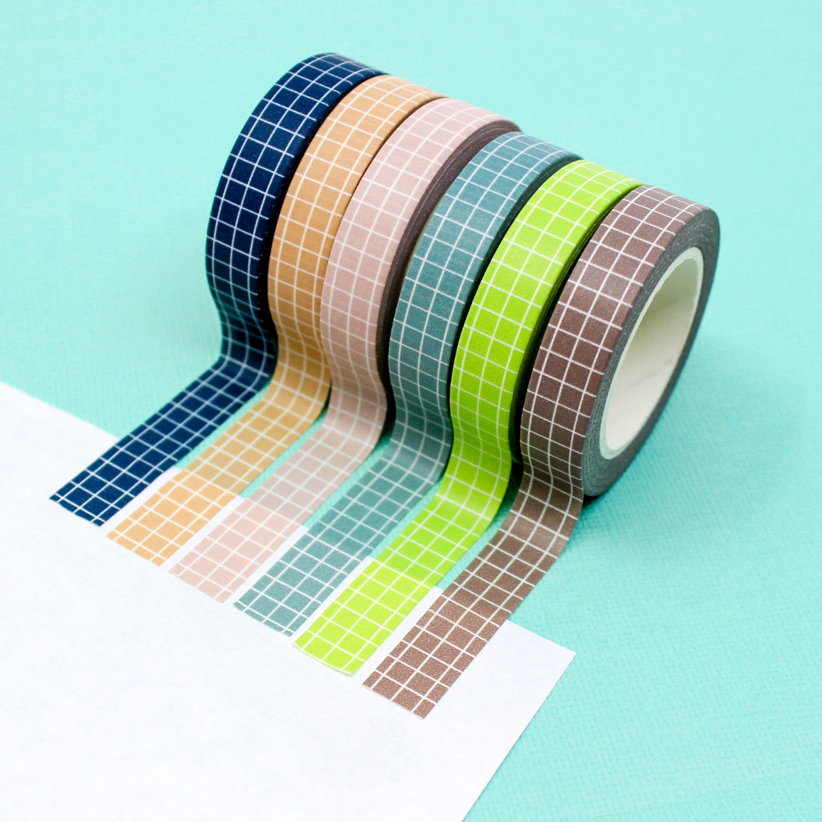 These colorful narrow grid tapes are functional and decorative, making them a must have for any planner, journal or calendar. These tapes come in Navy Blue, Blue, Pink, Green, Brown, and peachy Tan and are sold at BBB Supplies Craft Shop.