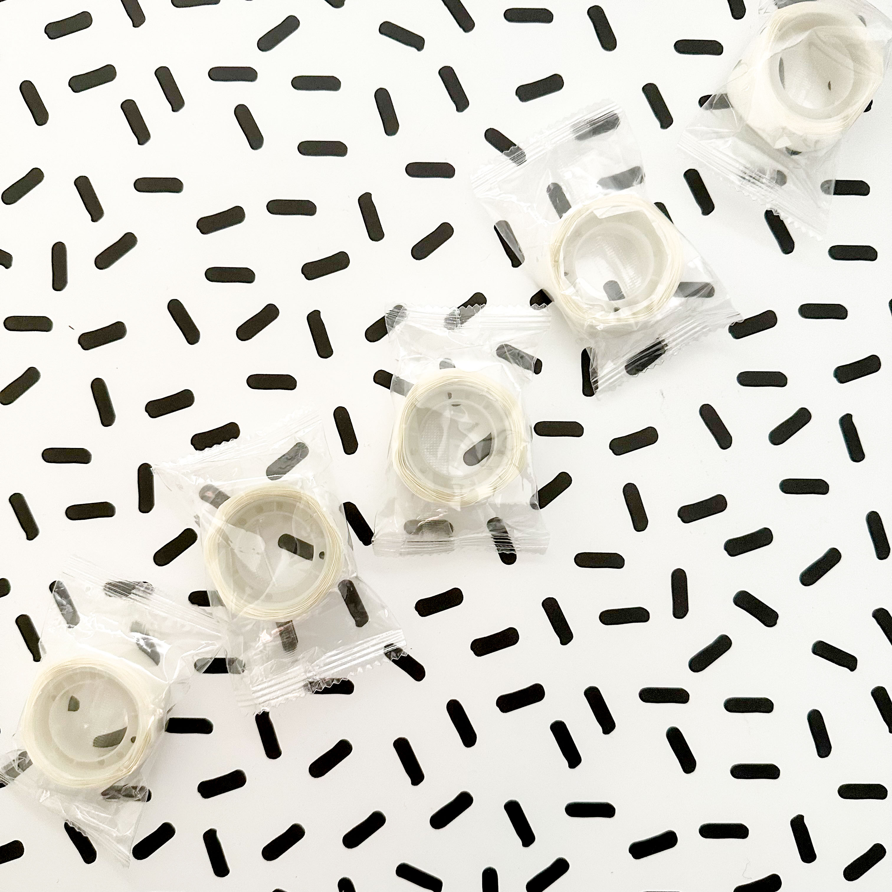 Single roll of double-sided adhesive Glue Dots for easy and mess-free crafting, ideal for scrapbooking and DIY projects.