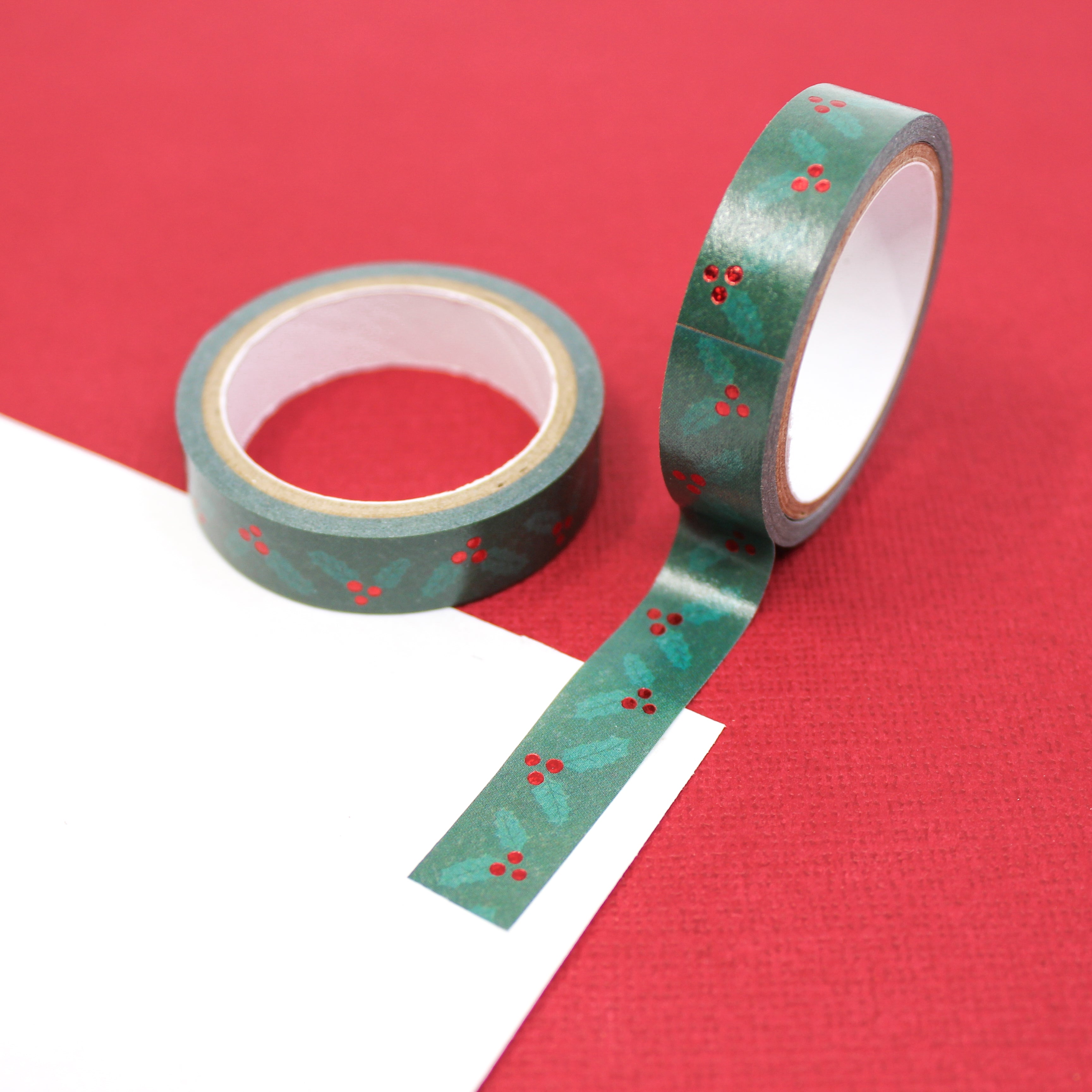 Elevate your holiday crafts with our narrow green holiday holly washi tape, featuring delicate holly leaf and berry designs, perfect for adding a touch of festive charm to your projects. This tape is sold at BBB Supplies Craft Shop.