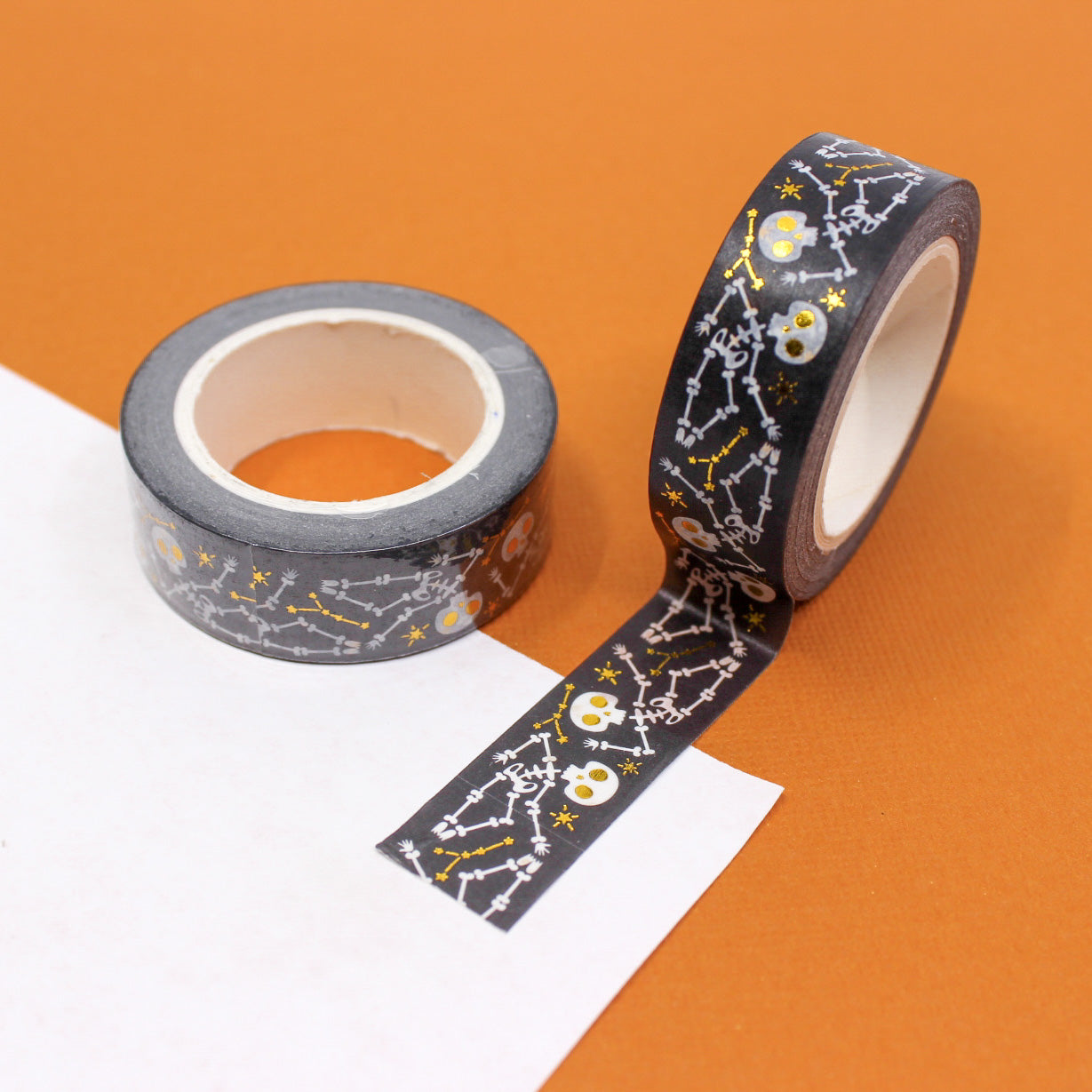 Embrace the macabre with our Gold Foil Skull and Bones Washi Tape, featuring a stylish pattern of skulls and bones in shimmering gold foil. Ideal for adding a touch of elegance to your spooky projects. This tape is sold at BBB Supplies craft Shop.