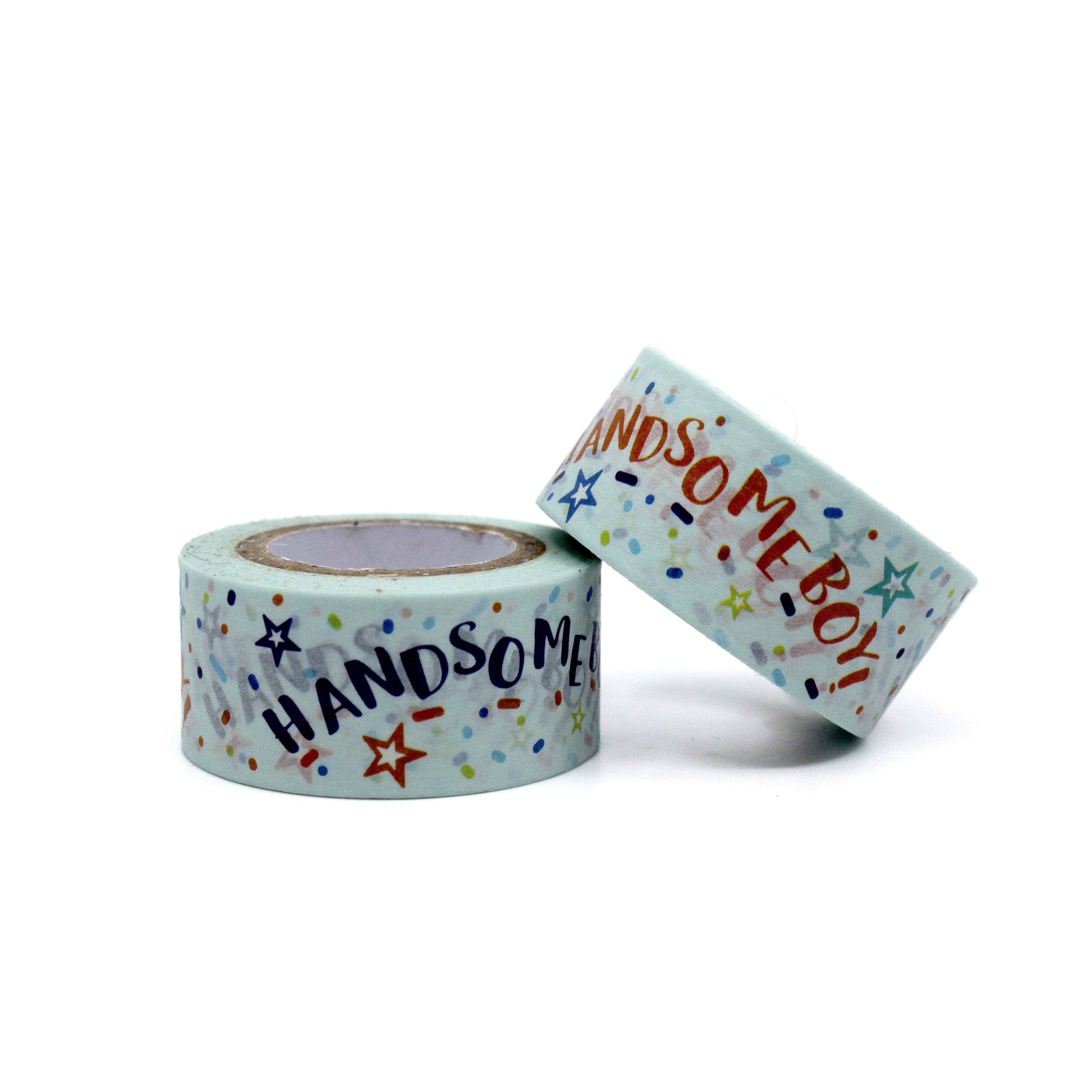 Two rolls of decorative washi tape featuring stars and celebration-themed lettering.