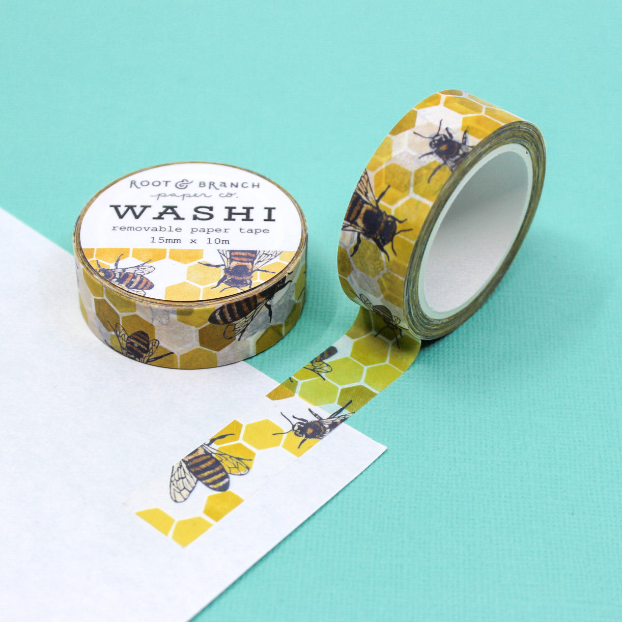 Capture nature's beauty with 'Honeybee on Yellow Hexagon Honeycomb' Washi Tape, a delightful tape featuring a charming honeybee against a vibrant hexagon honeycomb backdrop. This tape is from Root & Branch Co. and sold at BBB Supplies Craft Shop.