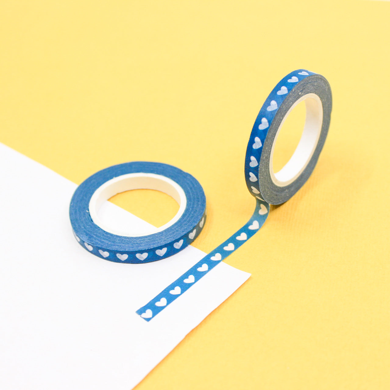 Elevate your crafts with our Narrow Blue Hearts Washi Tape, featuring a charming heart pattern in a calming shade of blue. Ideal for adding a sweet and decorative touch to your projects. This tape is sold at BBB Supplies Craft Shop.