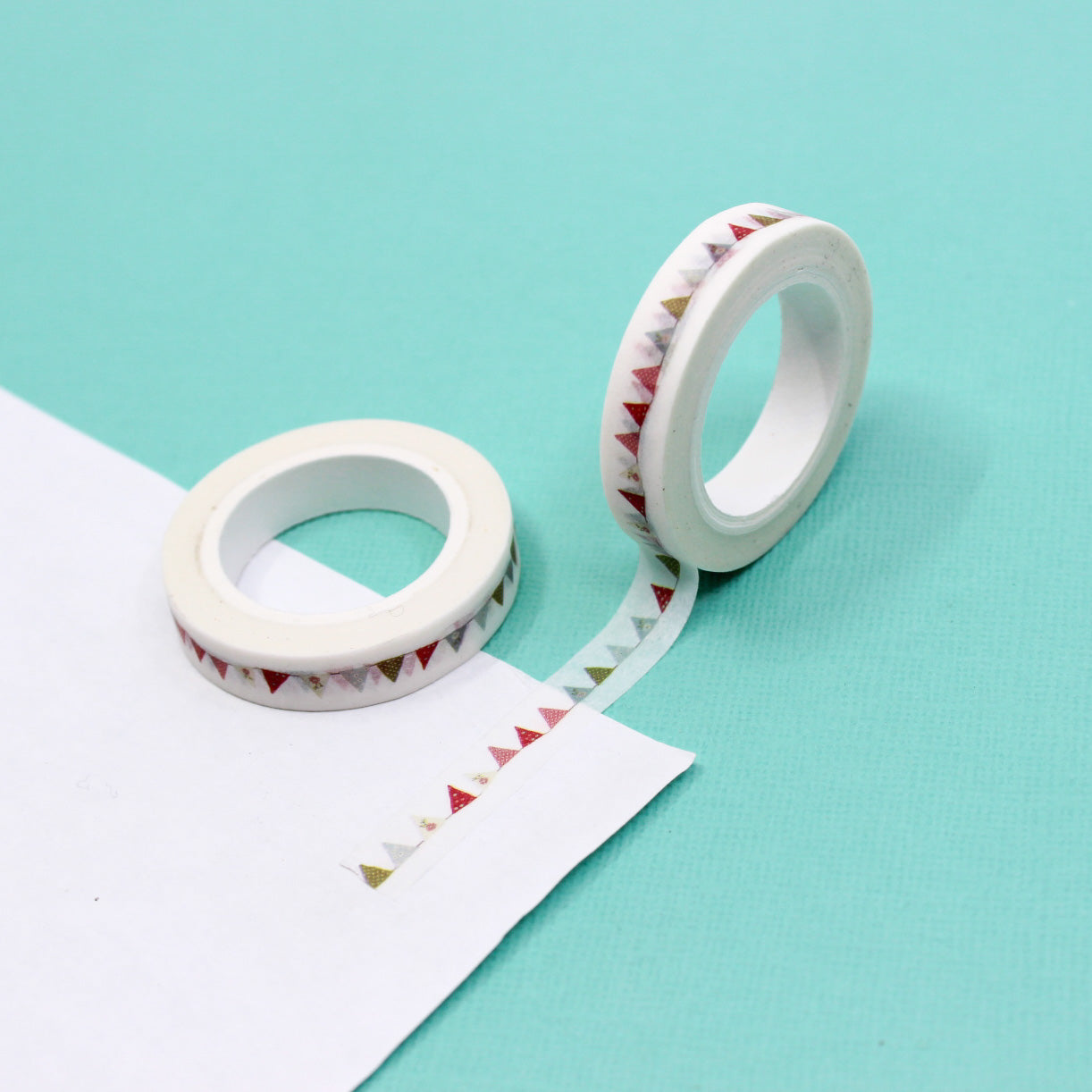 Elevate your projects with our Colorful Bunting Banner Flags Washi Tape, featuring a cheerful array of colorful flags. Ideal for adding a festive and celebratory touch to your crafts. This tape is sold at BBB Supplies Craft Shop.