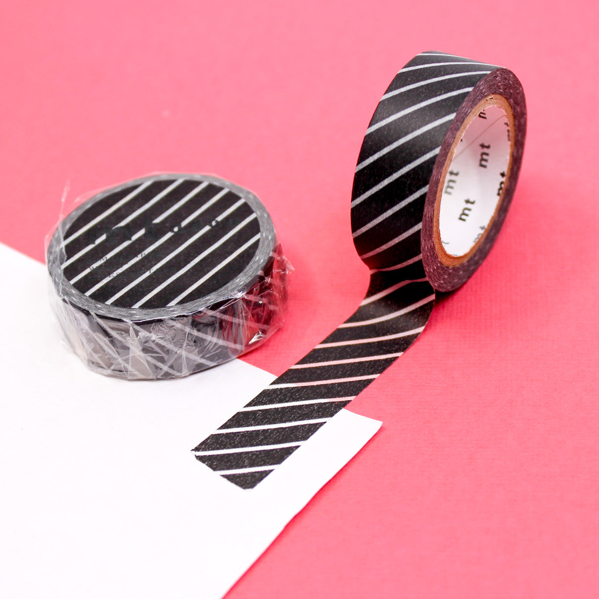 Infuse your projects with the appeal of clean lines using our washi tape, adorned with narrow diagonal stripes that add a subtle and stylish element to your crafts. This black Diagonal Striped Washi tape is from MT Brand Washi and sold at BBB Supplies Craft Shop.