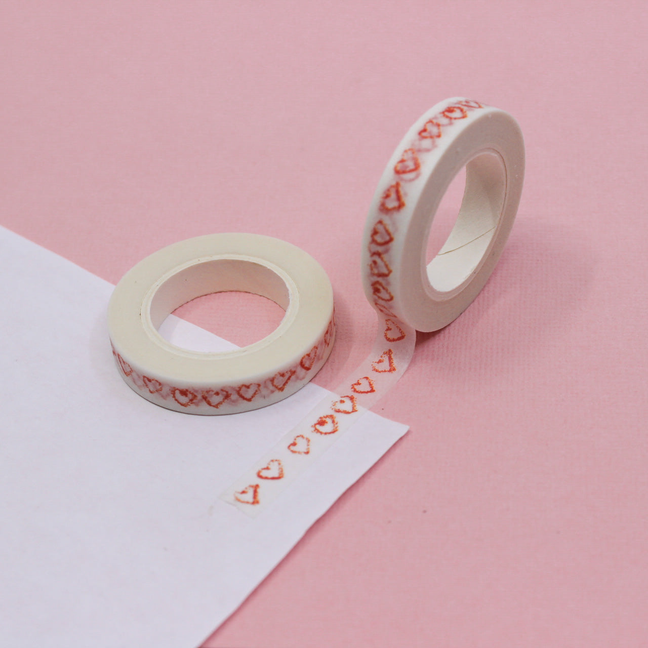 Elevate your projects with our Narrow Red Sketchy Hearts Border Washi Tape, adorned with charming and hand-drawn heart patterns. Ideal for adding a touch of playful romance to your crafts. This tape is sold at BBB Supplies Craft Shop.