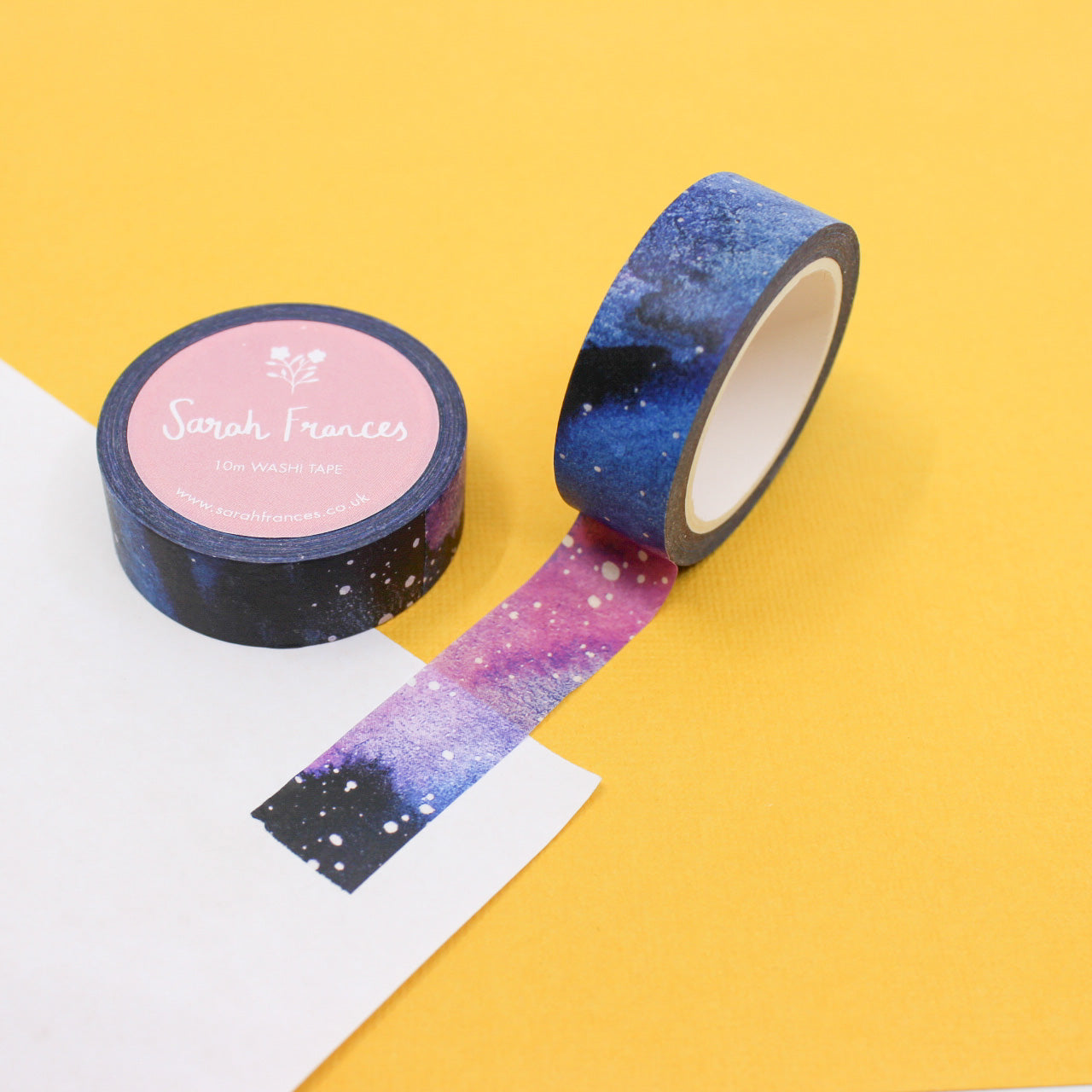 This washi tape is a purple and blue galaxy night sky with stars. It is from Sarah Frances Designs and sold at BBB Supplies Craft Shop.