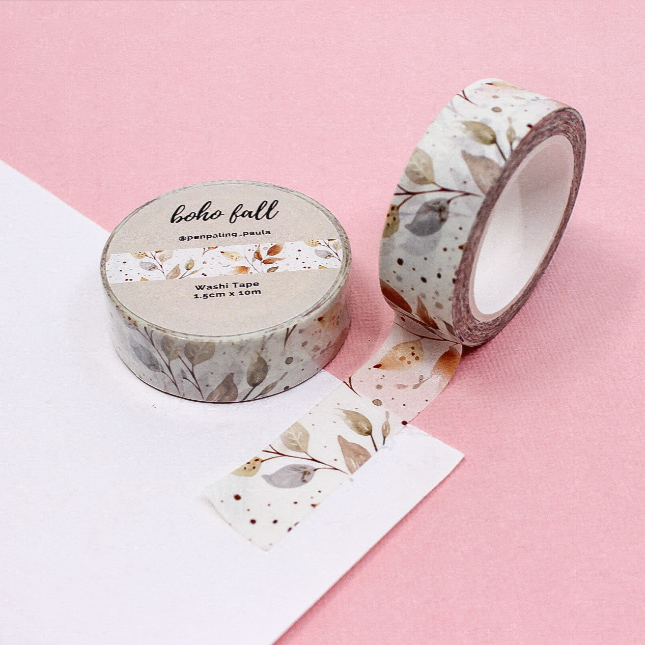Washi tape with a soft pastel blue and brown autumn leaf branch pattern, featuring a boho-inspired design perfect for fall crafting.