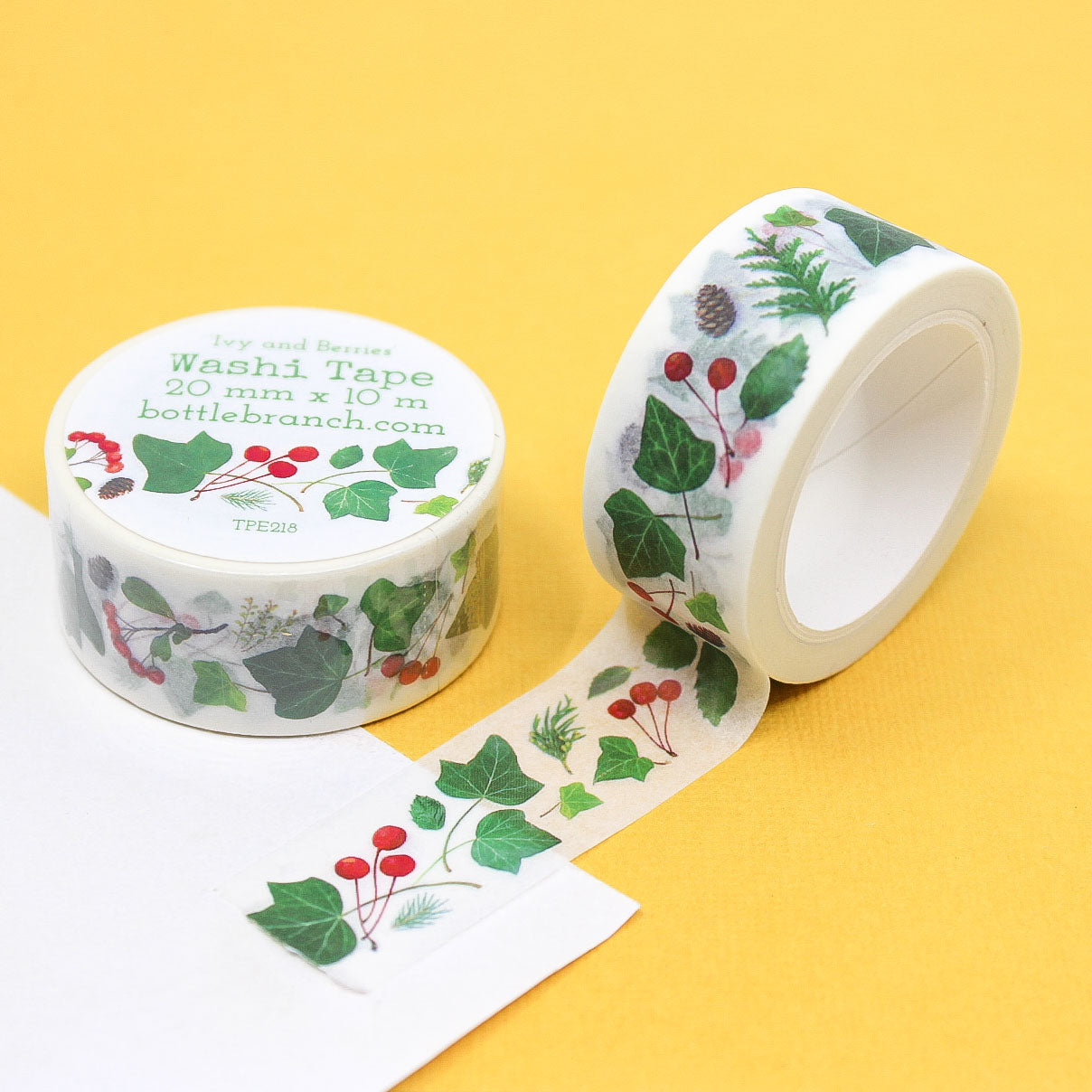 Planner-friendly floral washi tape with ivy and red berries on yellow background.
