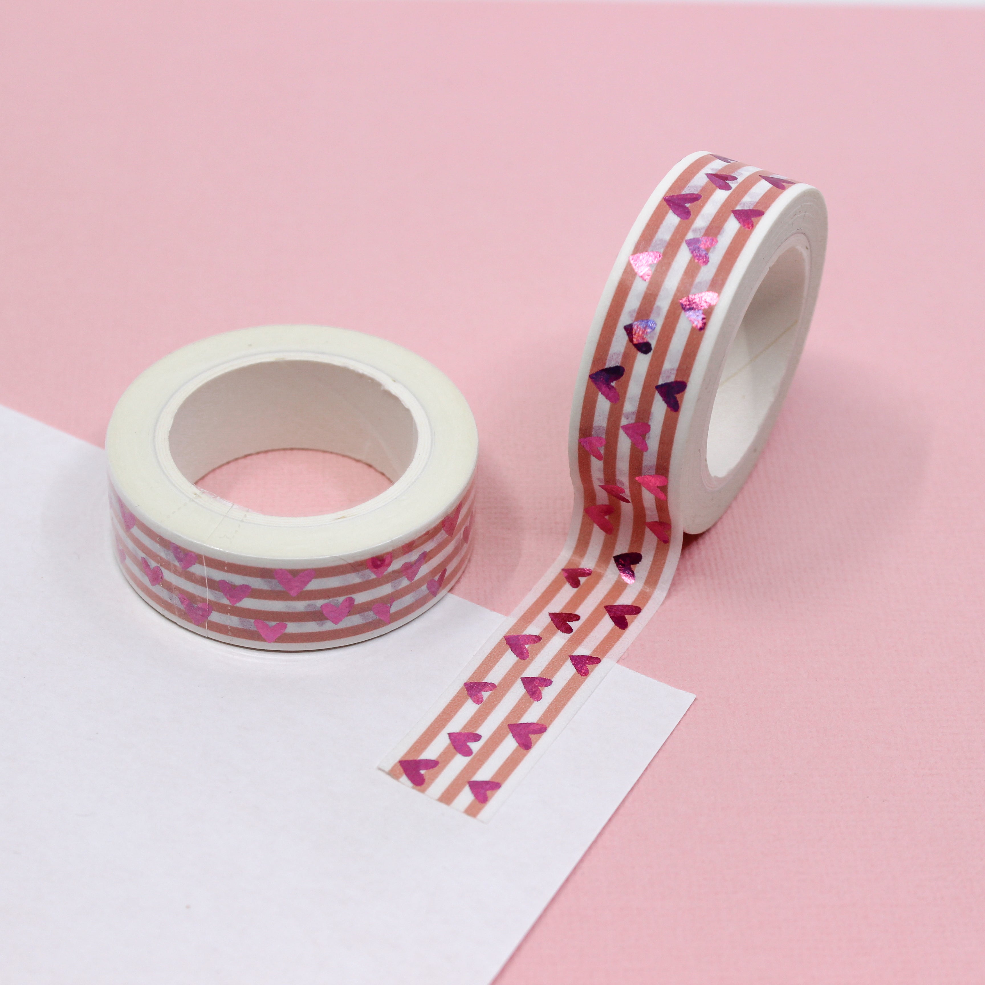This vibrant pink foil heart washi tape features a narrow pink stripe as a backdrop making it a colorful but elegant choice for your valentines spreads, craft projects, and BUJO layouts. This tape is sold at BBB Supplies craft shop.