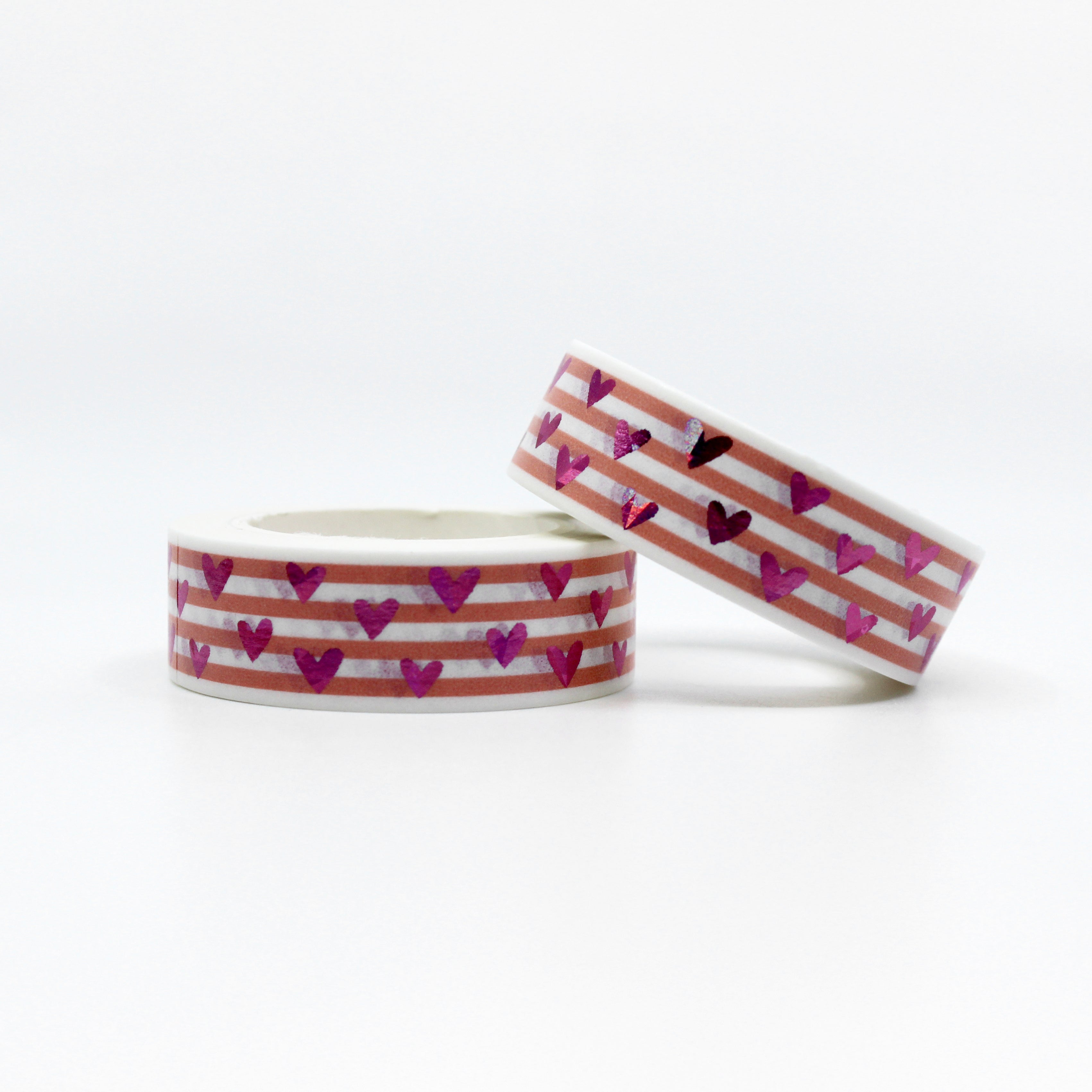 This vibrant pink foil heart washi tape features a narrow pink stripe as a backdrop making it a colorful but elegant choice for your valentines spreads, craft projects, and BUJO layouts. This tape is sold at BBB Supplies craft shop.