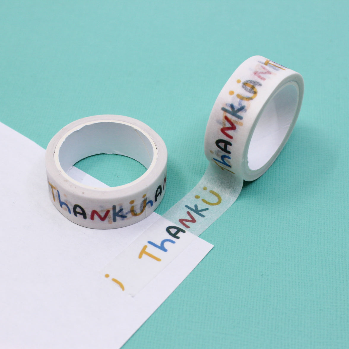 Vibrant washi tape featuring the words 'Thank U' alongside a cheerful smiling face. This playful design on a crisp white background adds a touch of gratitude and joy to your crafting projects. This tape is sold at BBB Supplies Craft Shop.