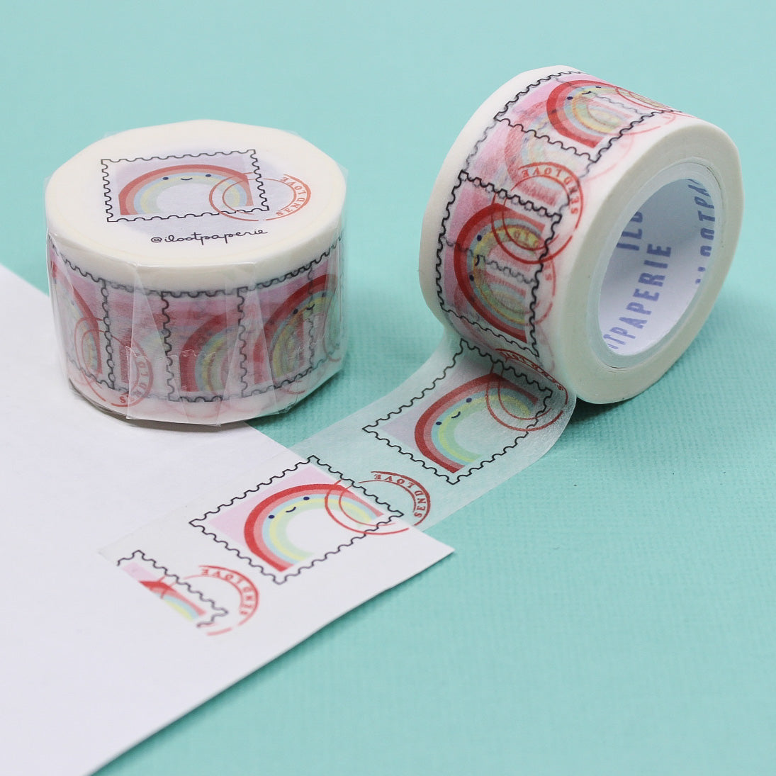 "Rainbow Stamp Snail Mail Washi Tape" features vibrant, multi-colored stamp designs against a crisp background, ideal for brightening up letters, packages, and creative projects with a fun, postal theme.