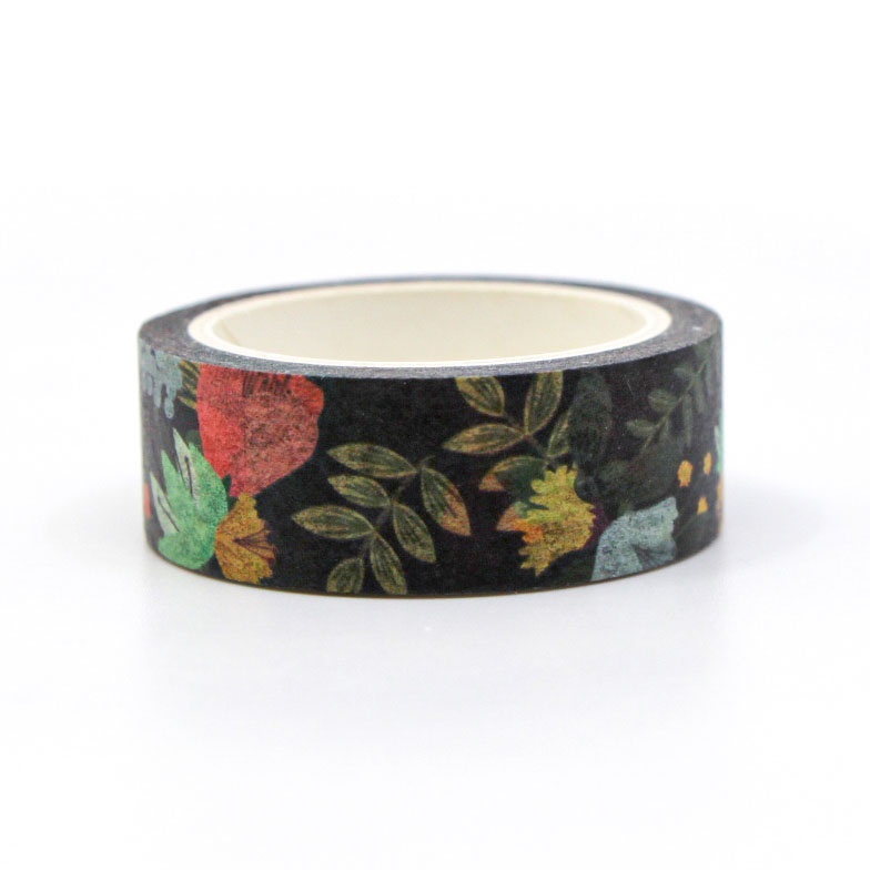Close-up of vibrant flower design washi tape roll on desk