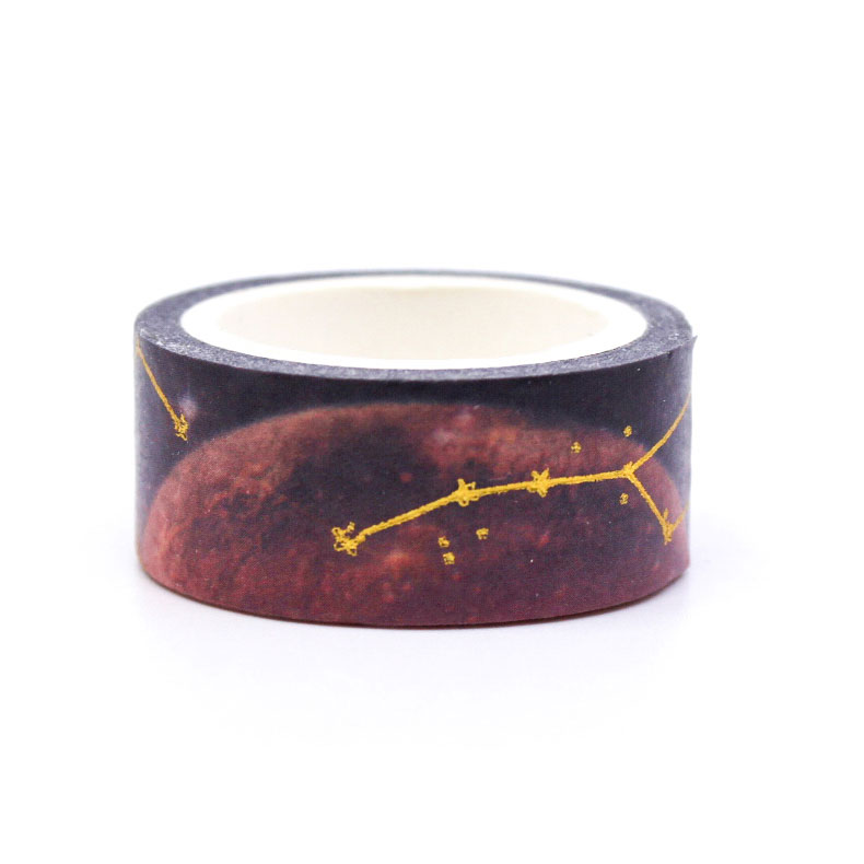 Purple night sky washi tape with metallic star constellations displayed on a desk.