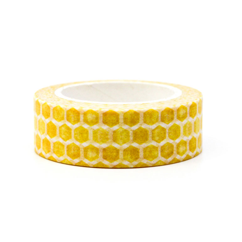 Yellow washi tape with hexagon print styled next to planner supplies.