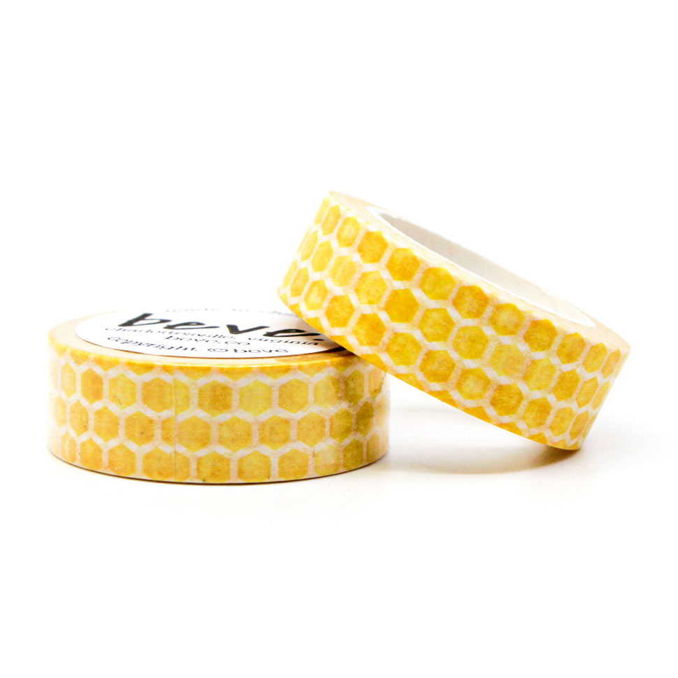 Flat lay of yellow geometric washi tape with stationery and pens.