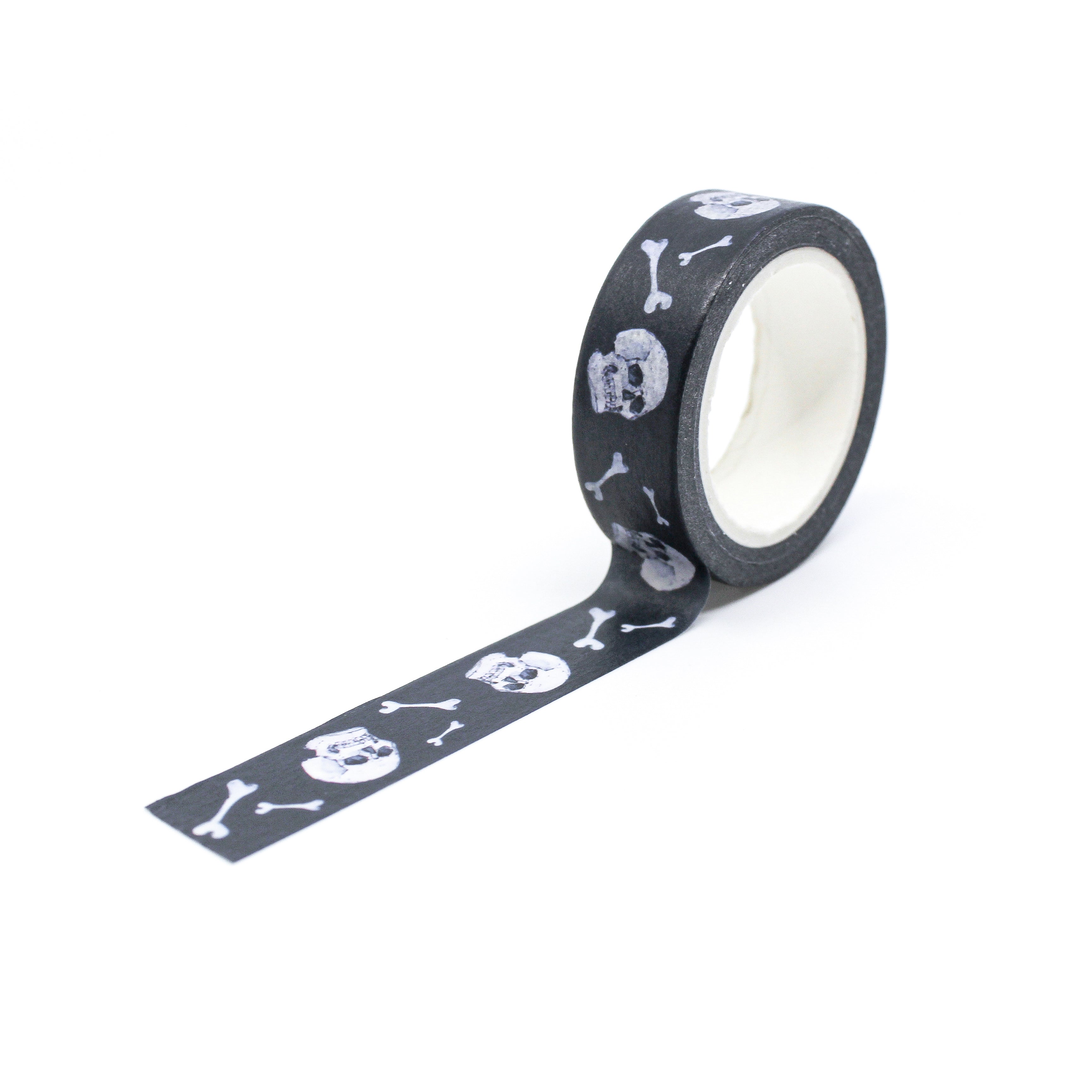 This is a full pattern repeat view of white skull and bone with black background themed washi tape from BBB Supplies Craft Shop