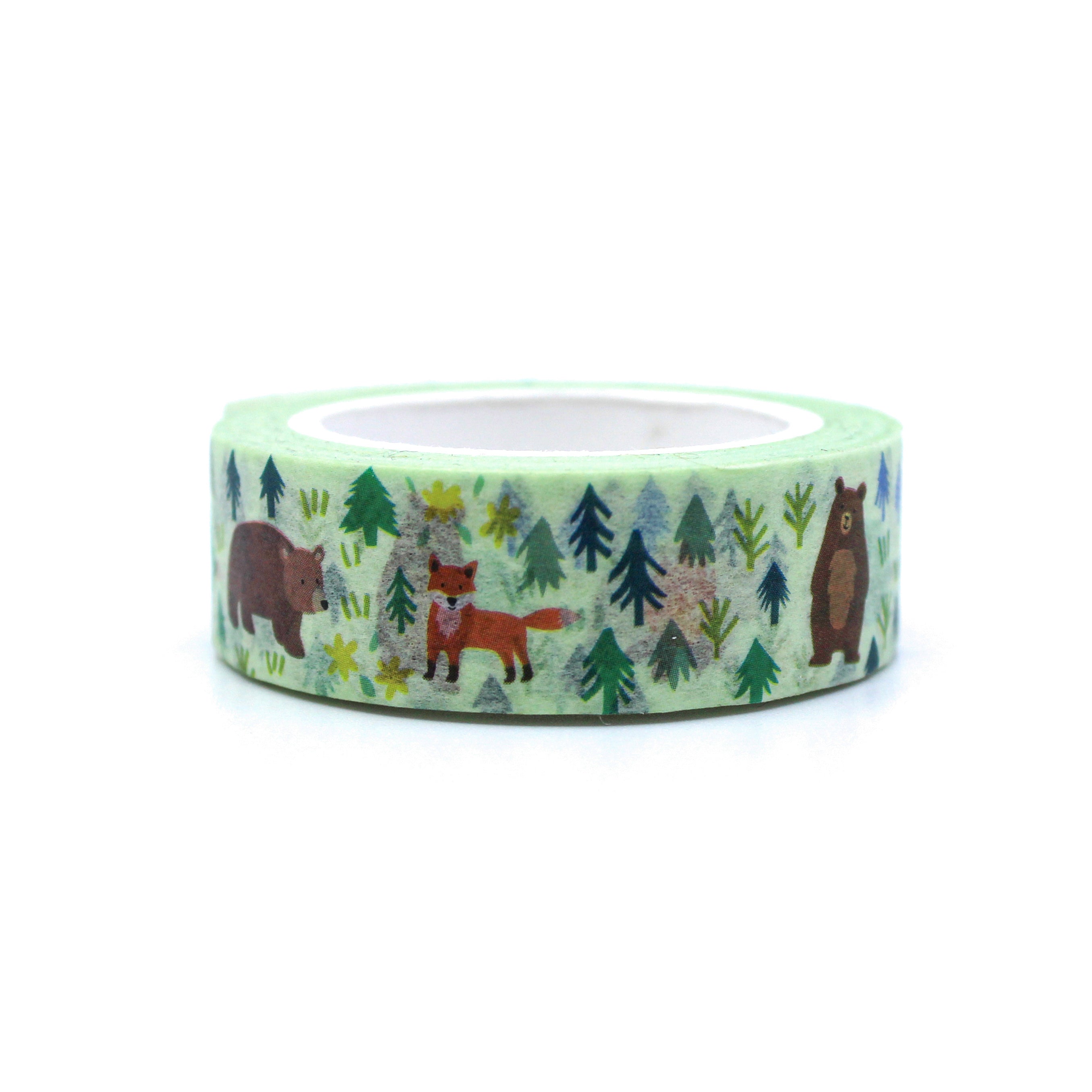 This is a picture of washi tape that has a pattern with a friendly fox, cute bear, camping tent and camp fire, surrounded by forest trees from BBB Supplies Craft Shop