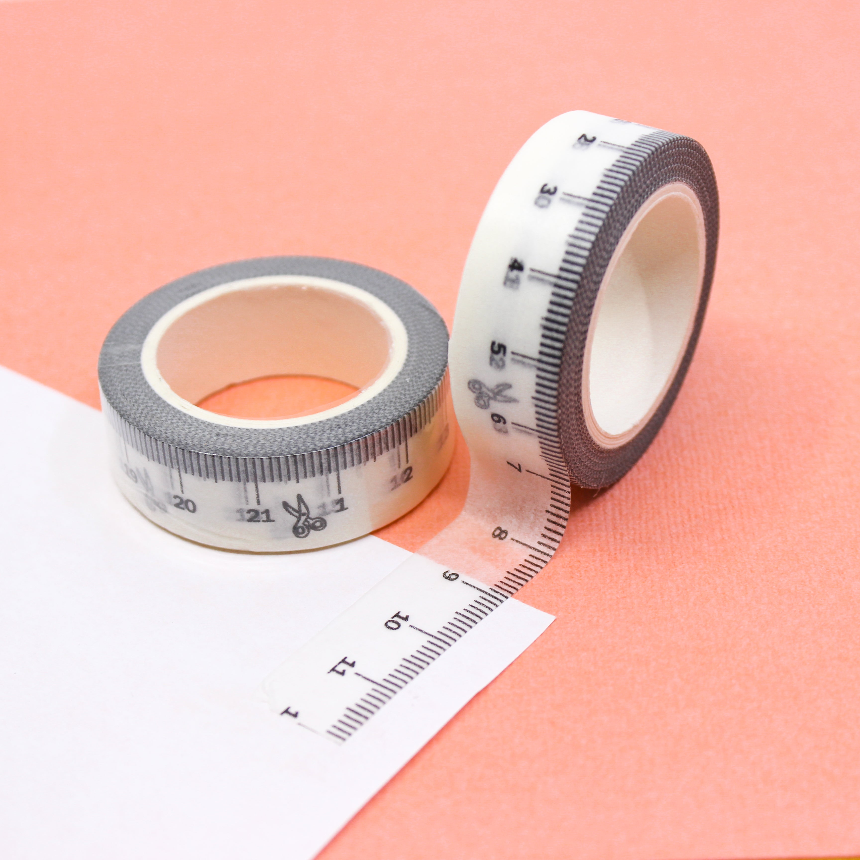 This is a white ruler or tape measure with a scissor view themed washi tape from BBB Supplies Craft Shop