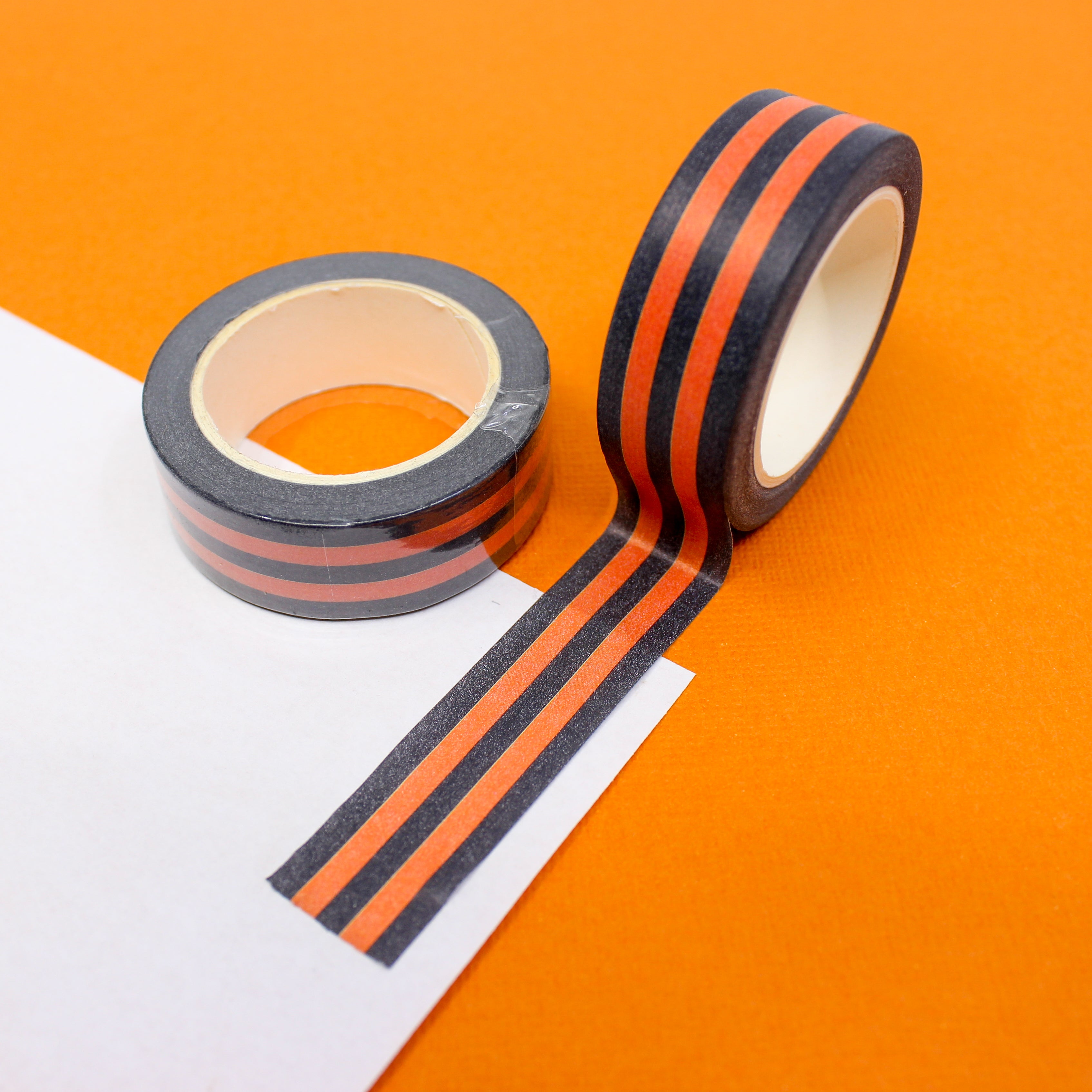 This is an orange and black horizontal stripe washi tape from BBB Supplies Craft Shop