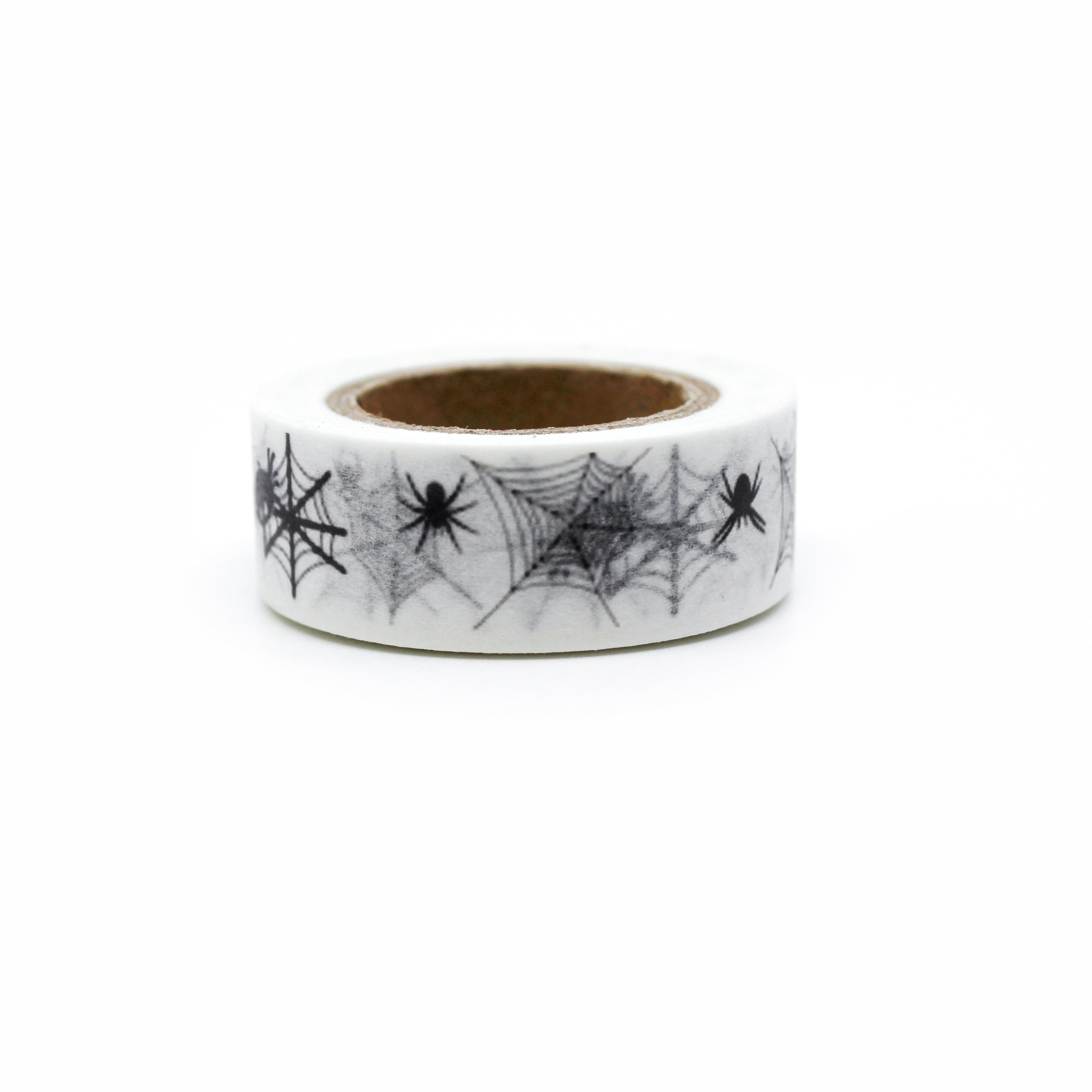 This is a spooky black spider with spiderwebs in a white background washi tape from BBB Supplies Craft Shop