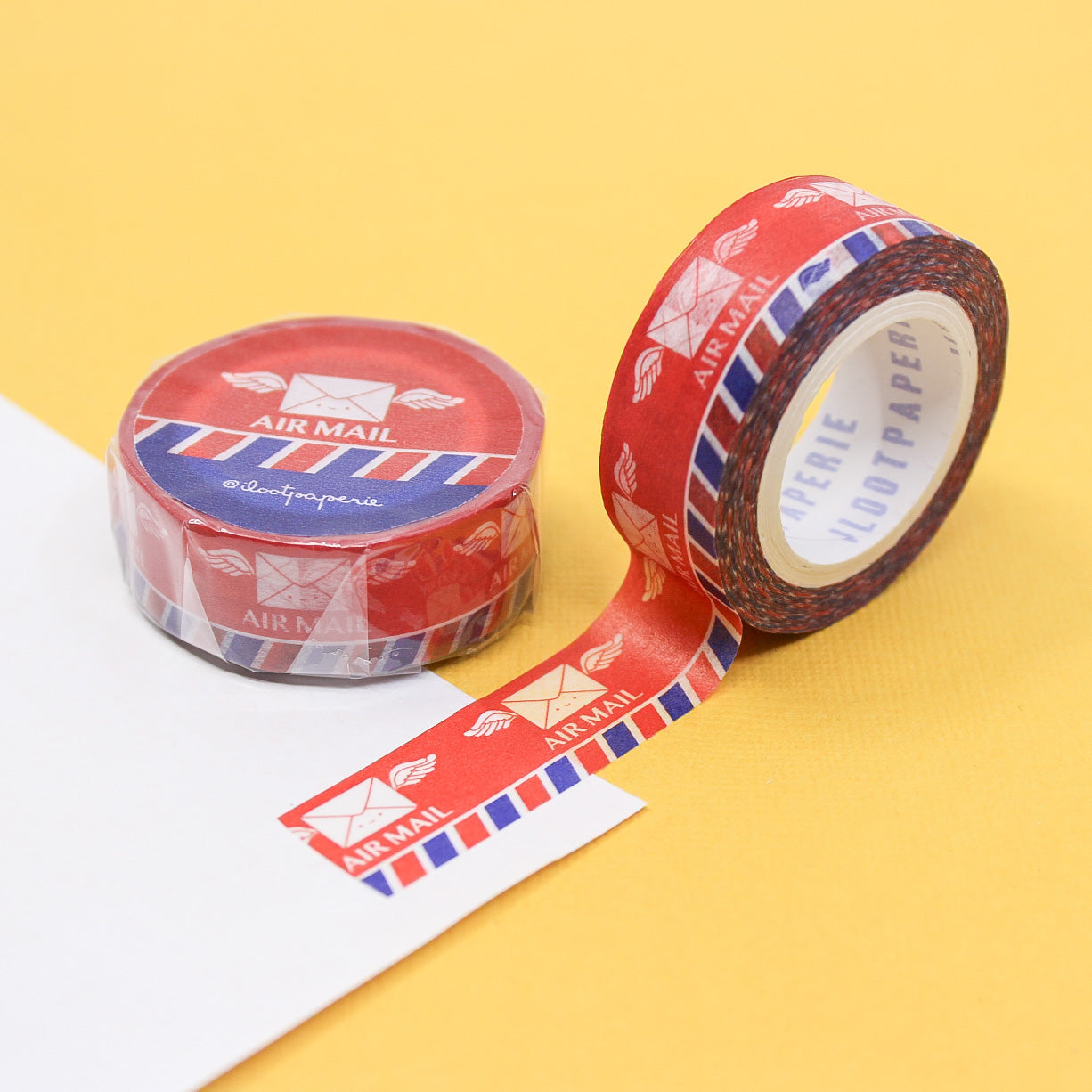  "Traditional Air Mail Washi Tape" showcases classic red and blue stripes with air mail motifs, perfect for adding a vintage touch to your correspondence, scrapbooking, and craft projects.