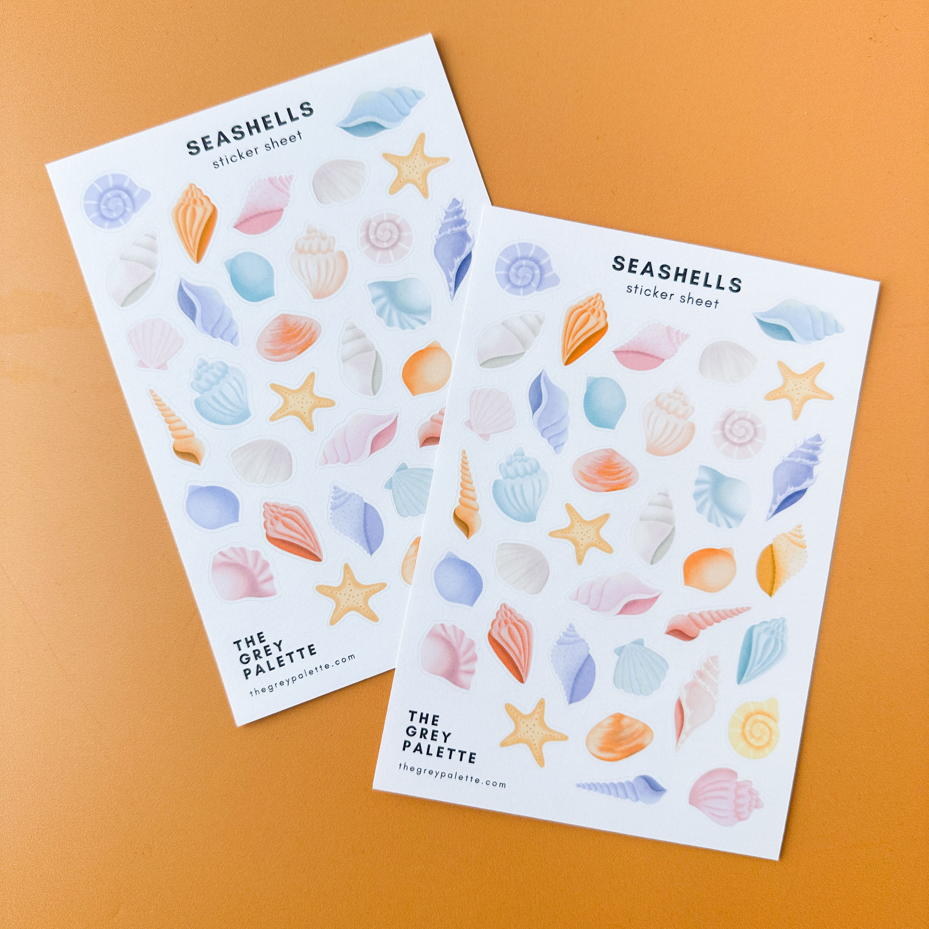 Sticker sheet featuring pastel-colored seashells in shades of pink, blue, lavender, and mint, perfect for journaling and crafts.