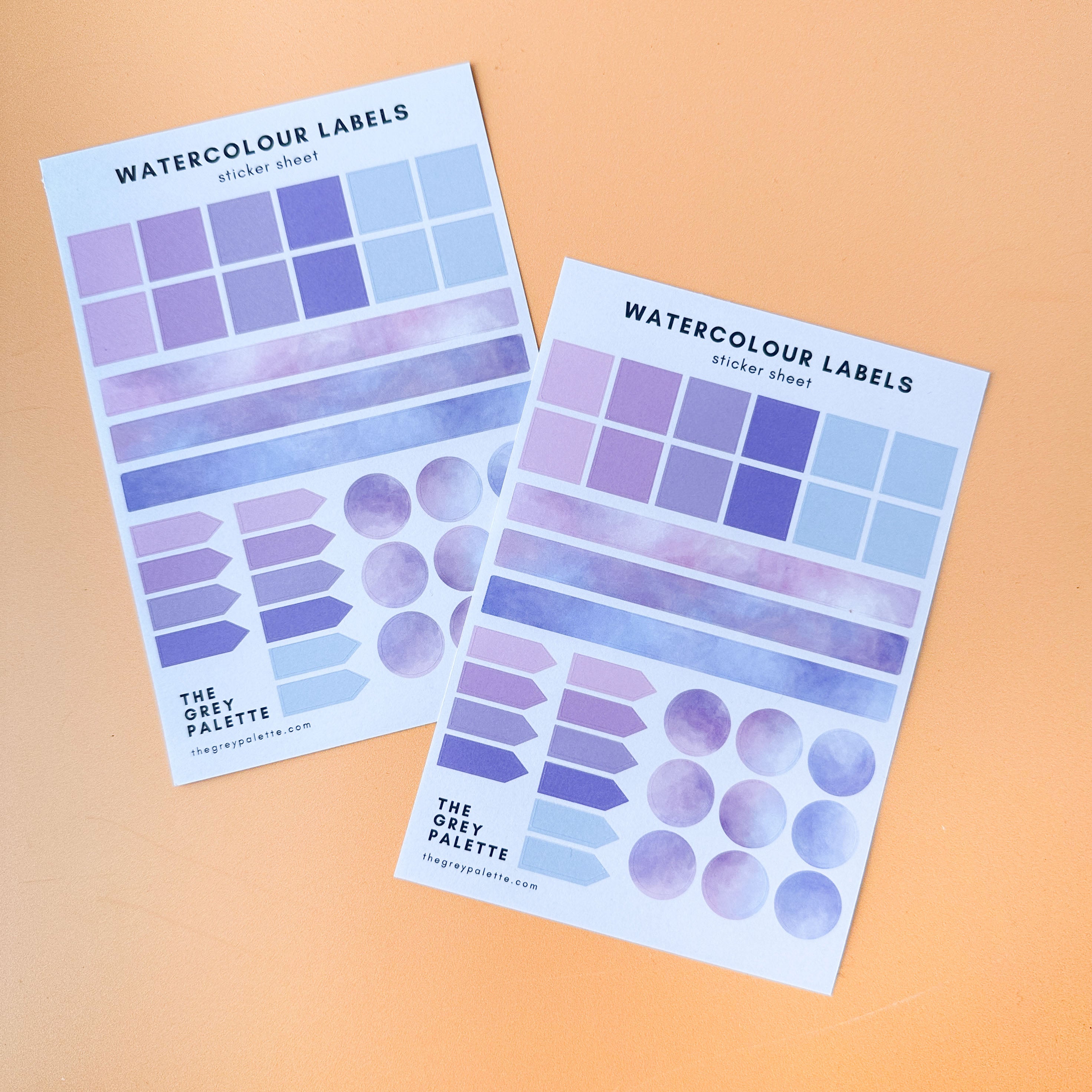 Purple to Blue colorway of Watercolor labels sticker sheets featuring squares, long labels, arrow pointers, and circles in three different pastel watercolor shades, ideal for journaling and planning.